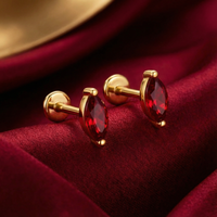 Side view of marquise cut simulated ruby earrings in 18K gold vermeil showing the setting on red silk.