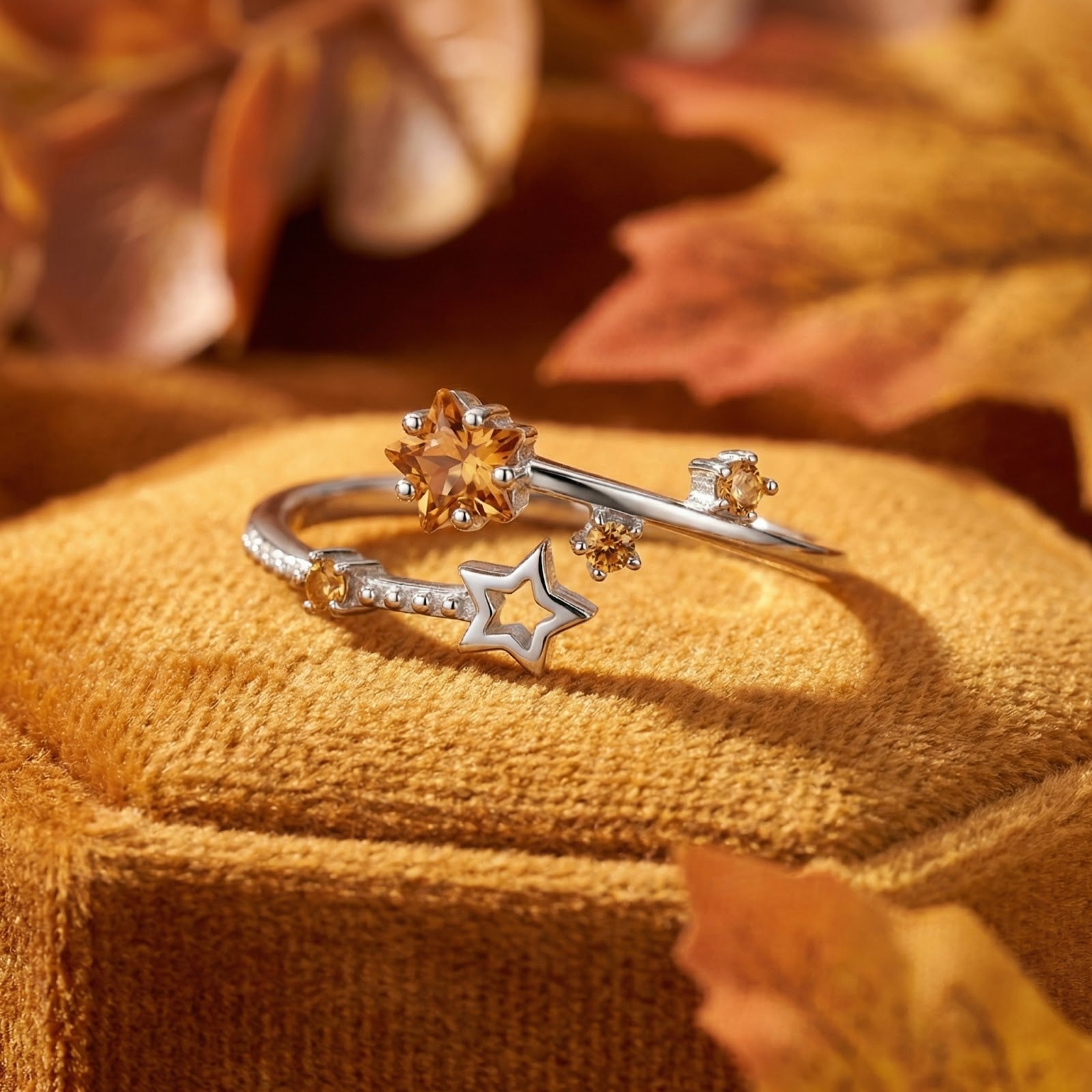 Macro view of the silver Astralis Star ring highlighting the star-cut simulated topaz and bypass setting.