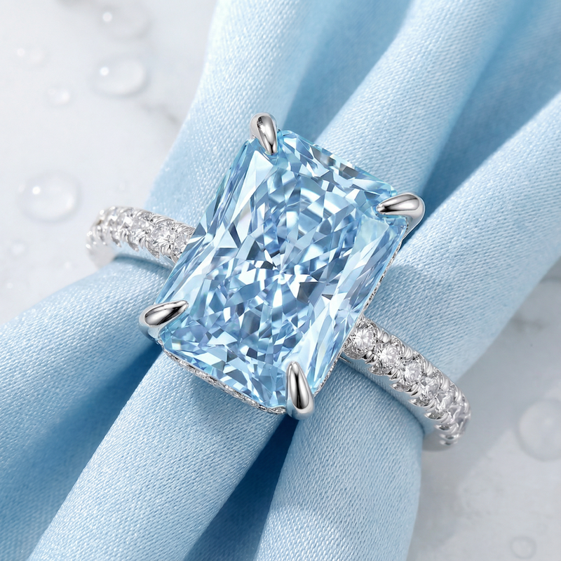 Macro view of a radiant-cut simulated aquamarine stone and pavé band in S925 sterling silver.