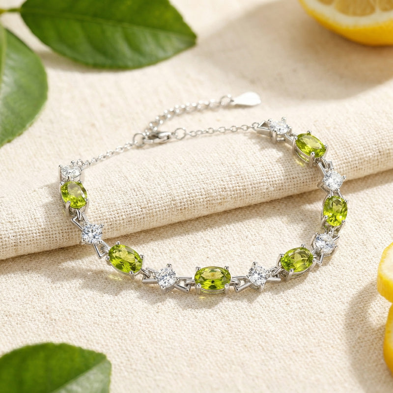 S925 sterling silver bracelet featuring oval-cut green peridot and round white stones in a lifestyle setting.