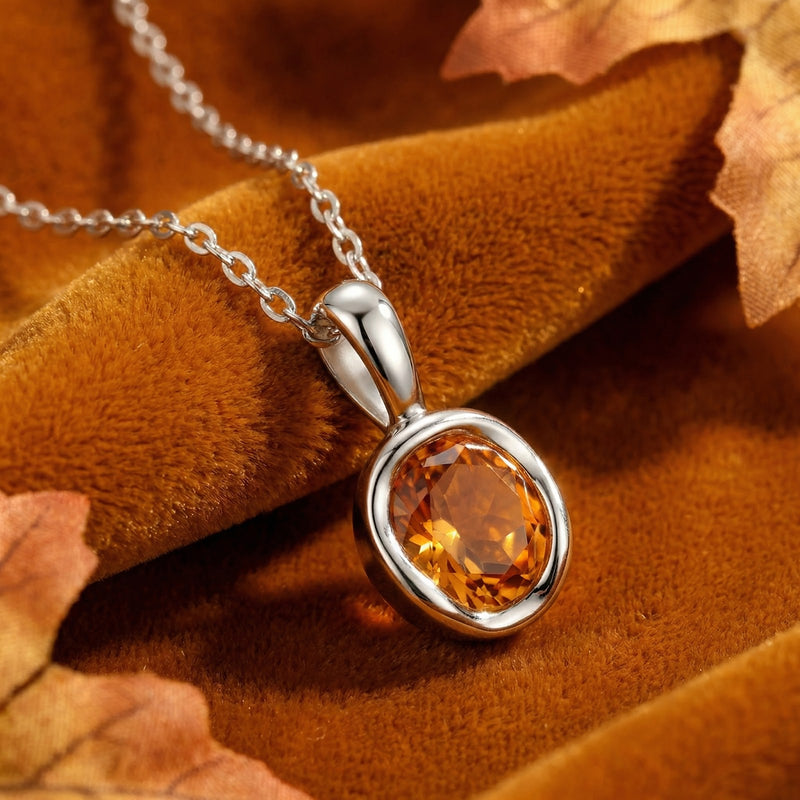 Close-up of the precision-cut simulated topaz and sterling silver bezel setting of the Arisienne necklace.