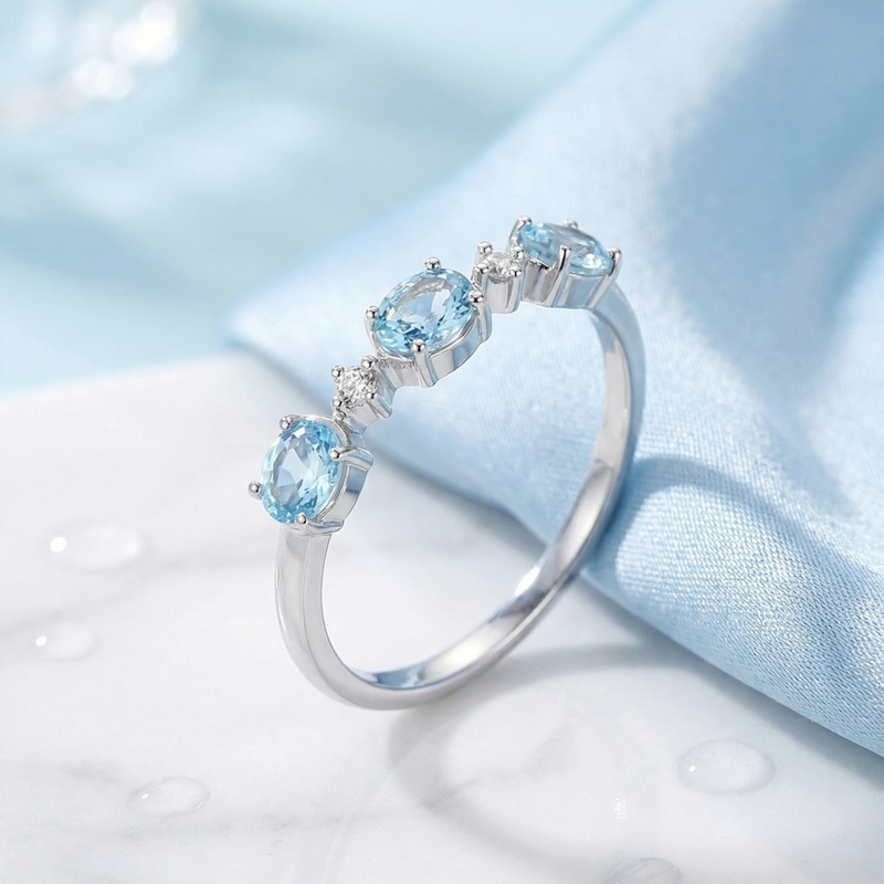 Angled view of the S925 sterling silver Maris bypass ring showing the low-profile simulated aquamarine setting.