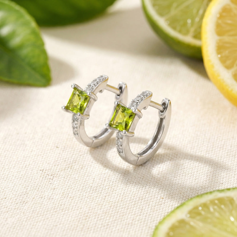 Side profile of square-cut simulated peridot sterling silver earrings with lime slices and leaves.