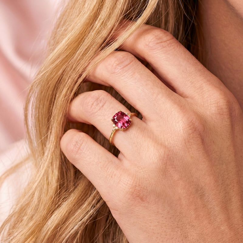 Model wearing the cushion cut simulated pink tourmaline gold vermeil ring on her finger.