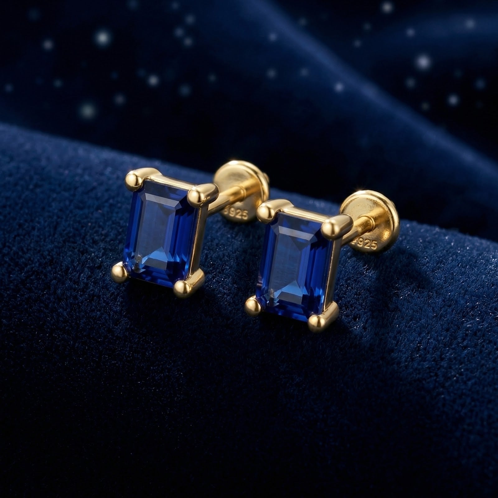 Macro shot of baguette-cut blue simulated sapphire stud earrings in 18K gold vermeil showing stone facets.