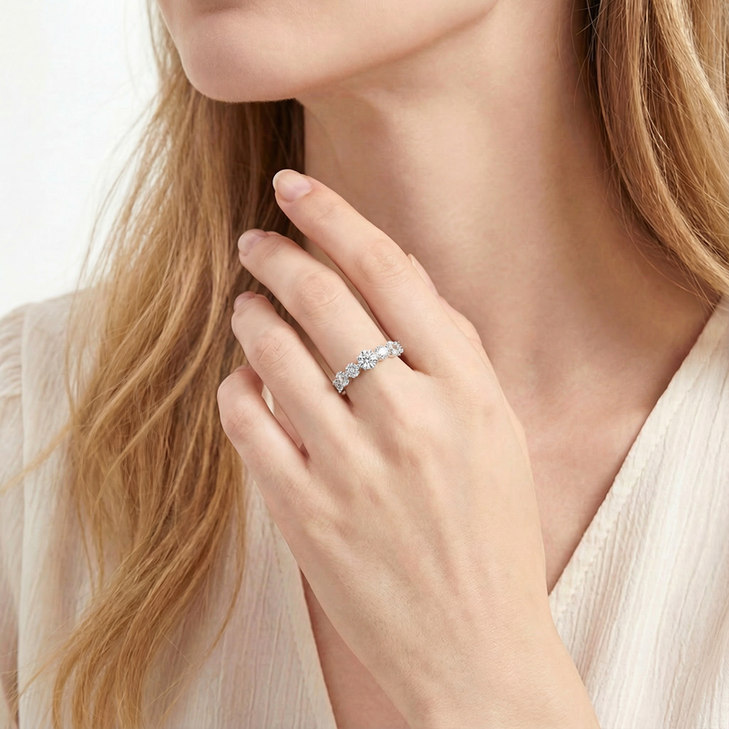 Model wearing the Lucianne S925 sterling silver half-eternity band with simulated diamonds on her ring finger.