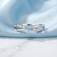 Sylphide S925 sterling silver ring with round cut simulated aquamarine on blue silk and marble.