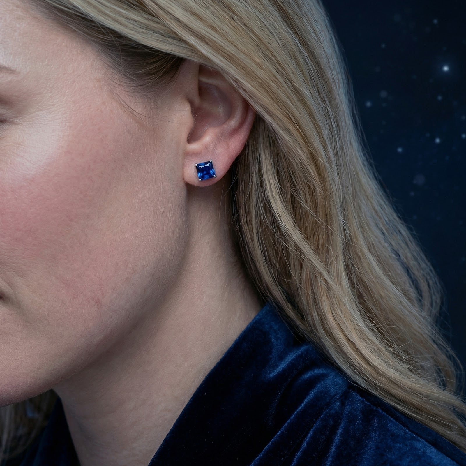 Profile view of a model wearing the Elianelle square simulated sapphire earring in 18K rose gold vermeil.