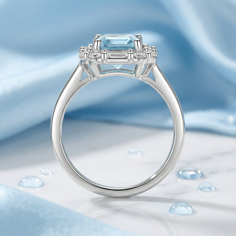 Profile view of the Linnea sterling silver halo ring showing the octagon cut light blue stone and intricate setting.