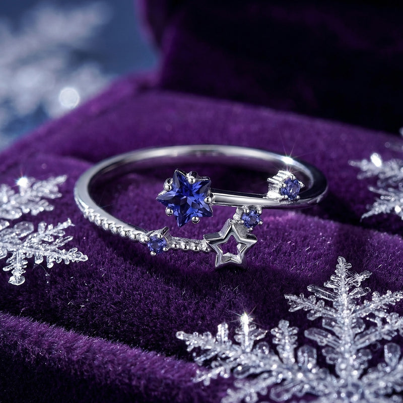 Top-down macro view of the sterling silver Nova Stellar ring with star-cut blue simulated tanzanite and round accents.