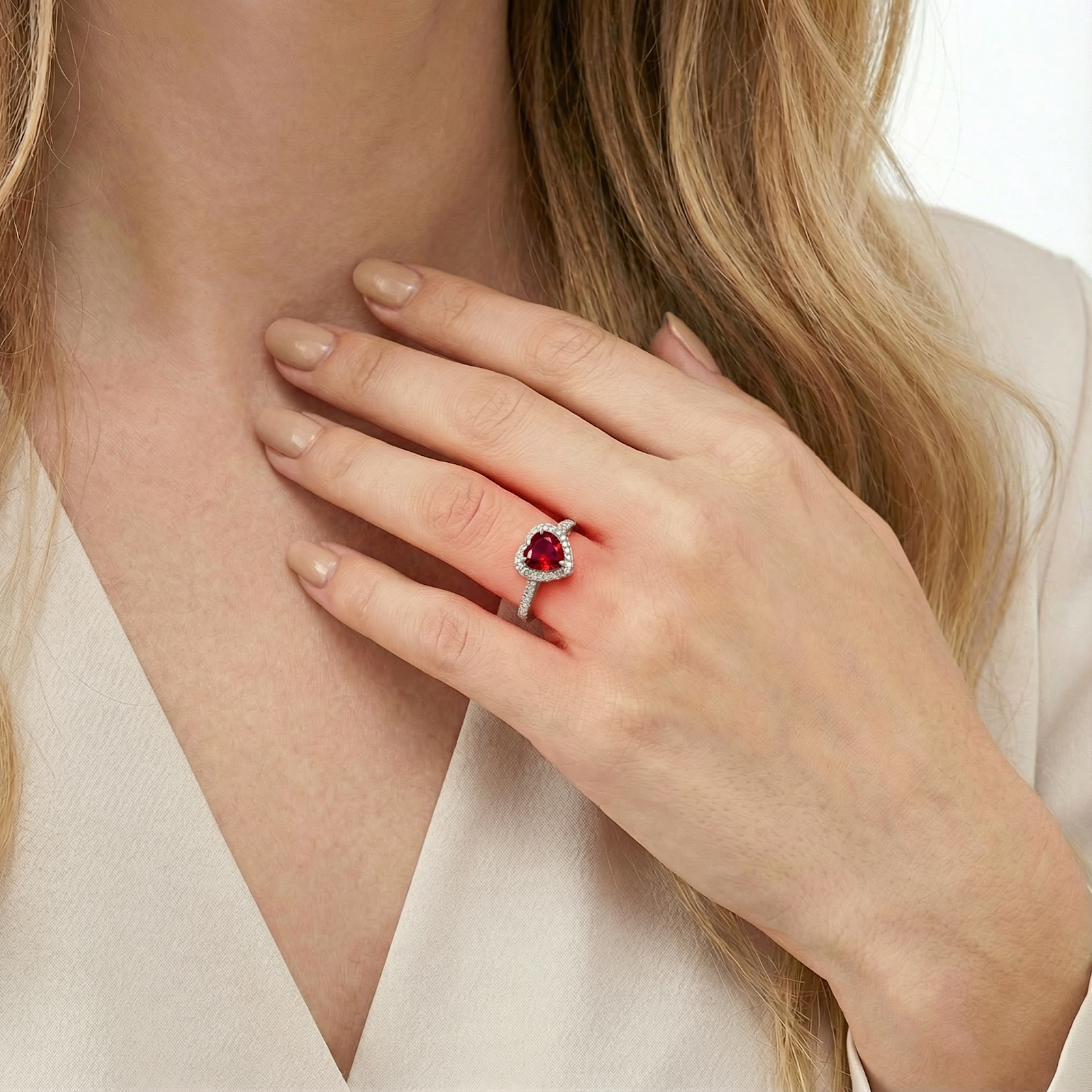 Close-up of a woman wearing the Valerissa heart-shaped red ruby ring in S925 sterling silver.