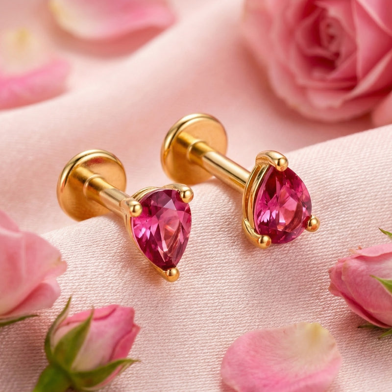 18K gold vermeil stud earrings with pear-cut simulated pink tourmaline stones displayed on pink fabric with rosebuds.