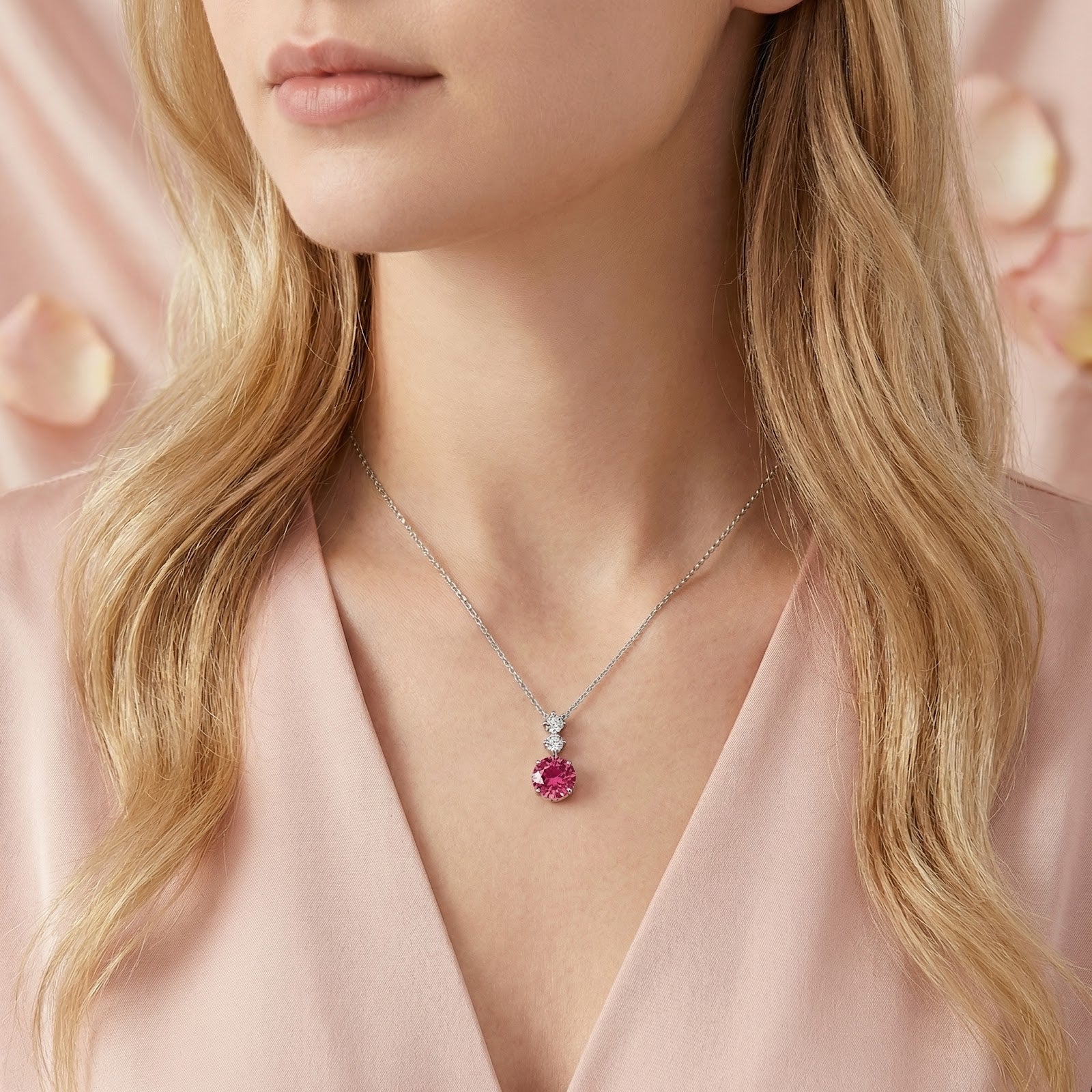 Model wearing the sterling silver Luvia pendant featuring a vivid raspberry round-cut pink tourmaline.