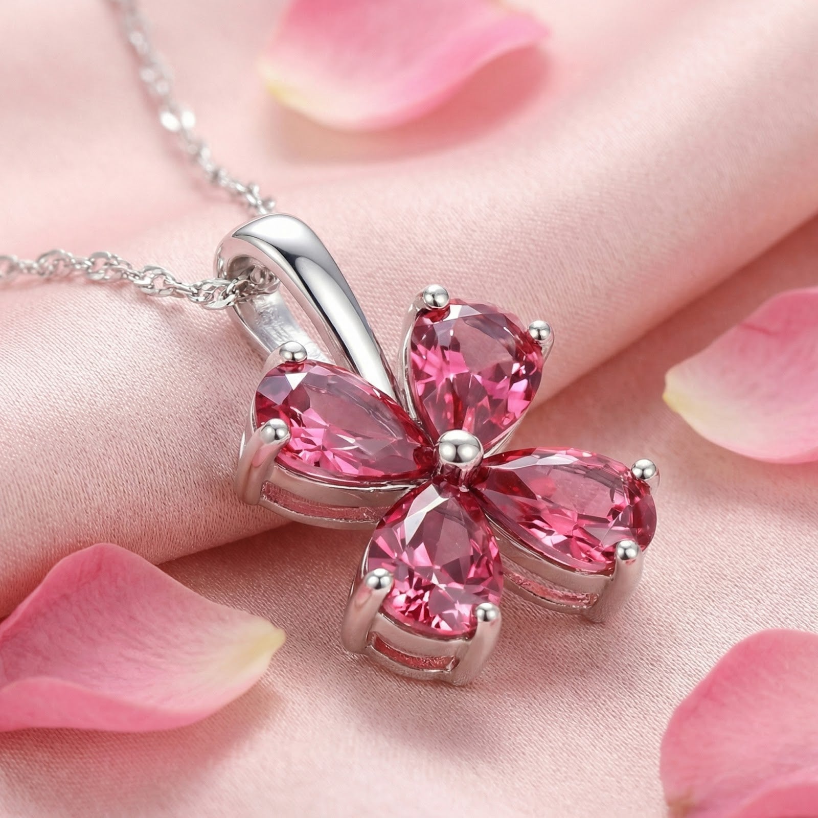 Close-up of the Petalina flower pendant in sterling silver showing pear-cut pink tourmaline stones and prong settings.