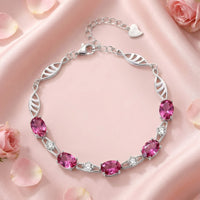Nerisara leaf bracelet in S925 sterling silver with oval pink tourmaline stones on pink satin with rose petals.