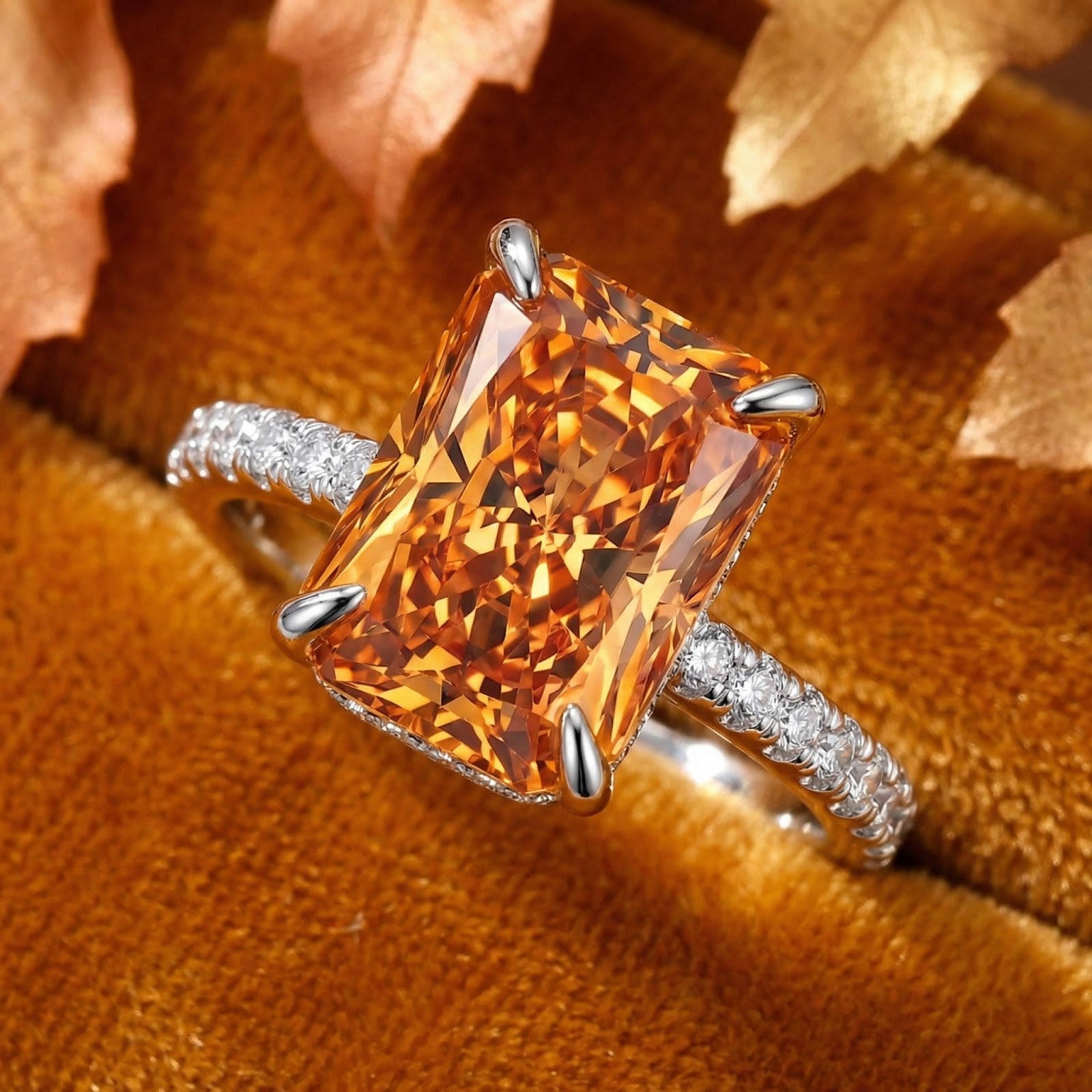 Macro view of a radiant cut simulated topaz and pavé setting on a rhodium-finished sterling silver ring.