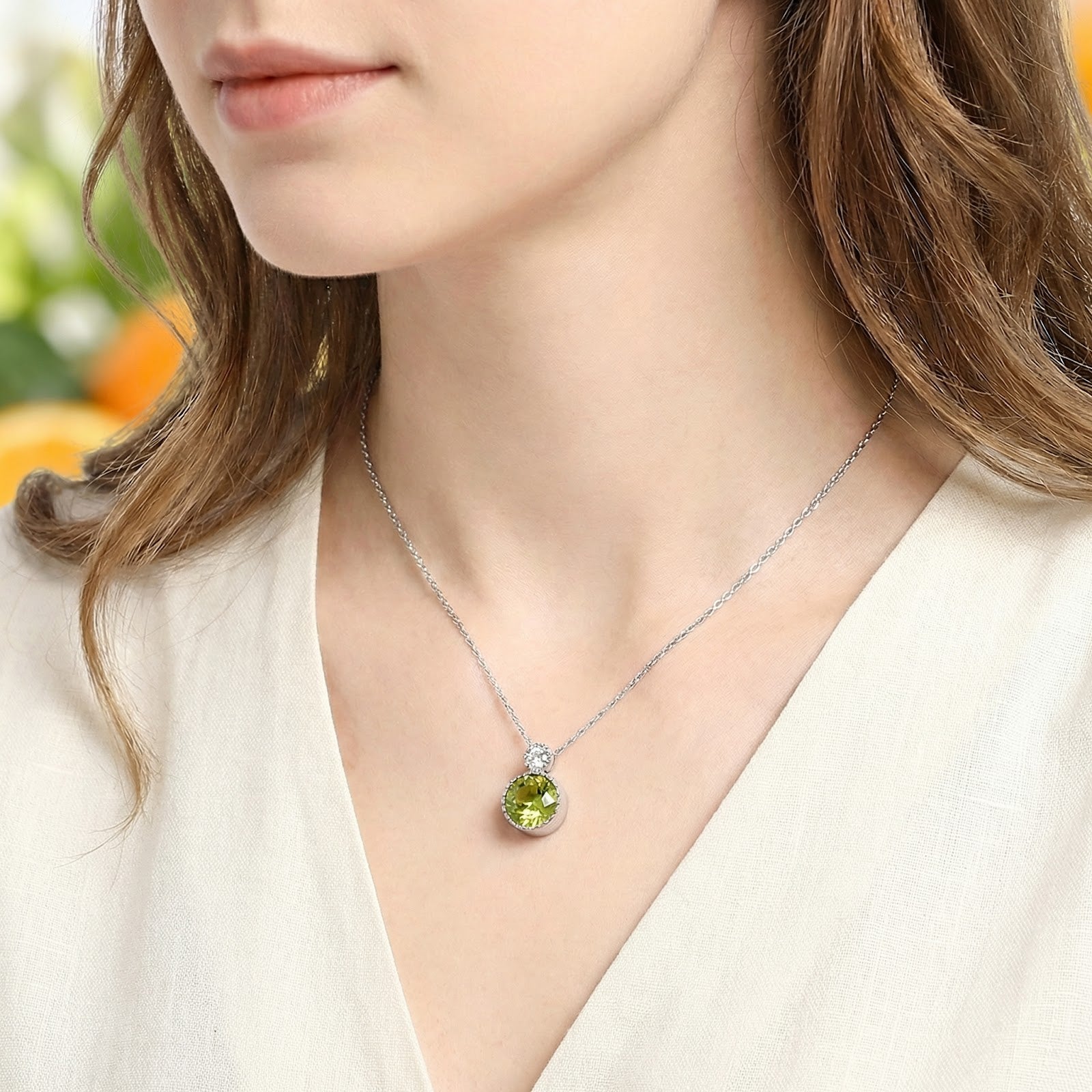 Model wearing the S925 sterling silver necklace with a vibrant round-cut simulated peridot drop pendant.