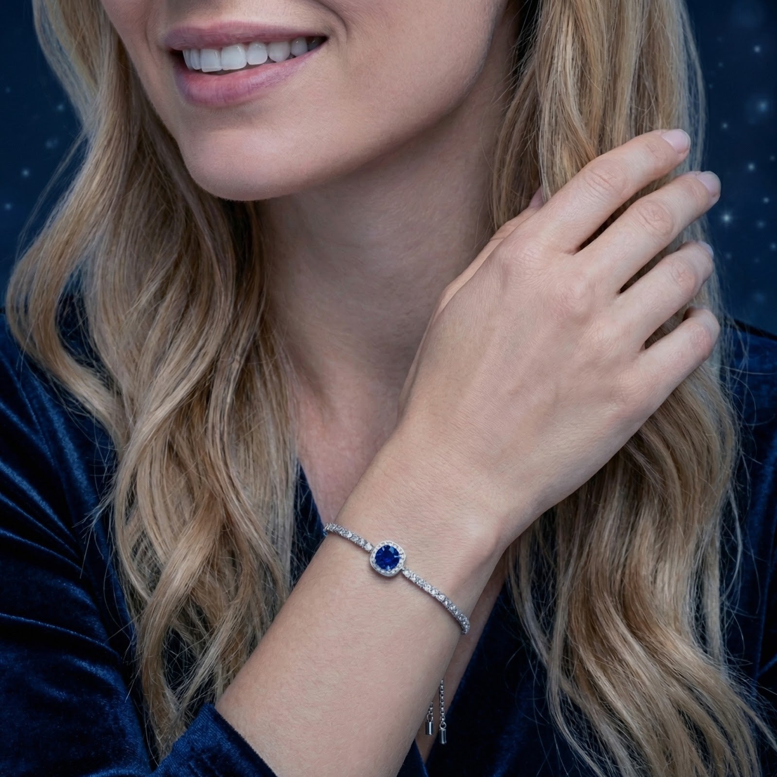 Woman smiling while wearing the sterling silver Caelisse bolo bracelet with a blue simulated sapphire.