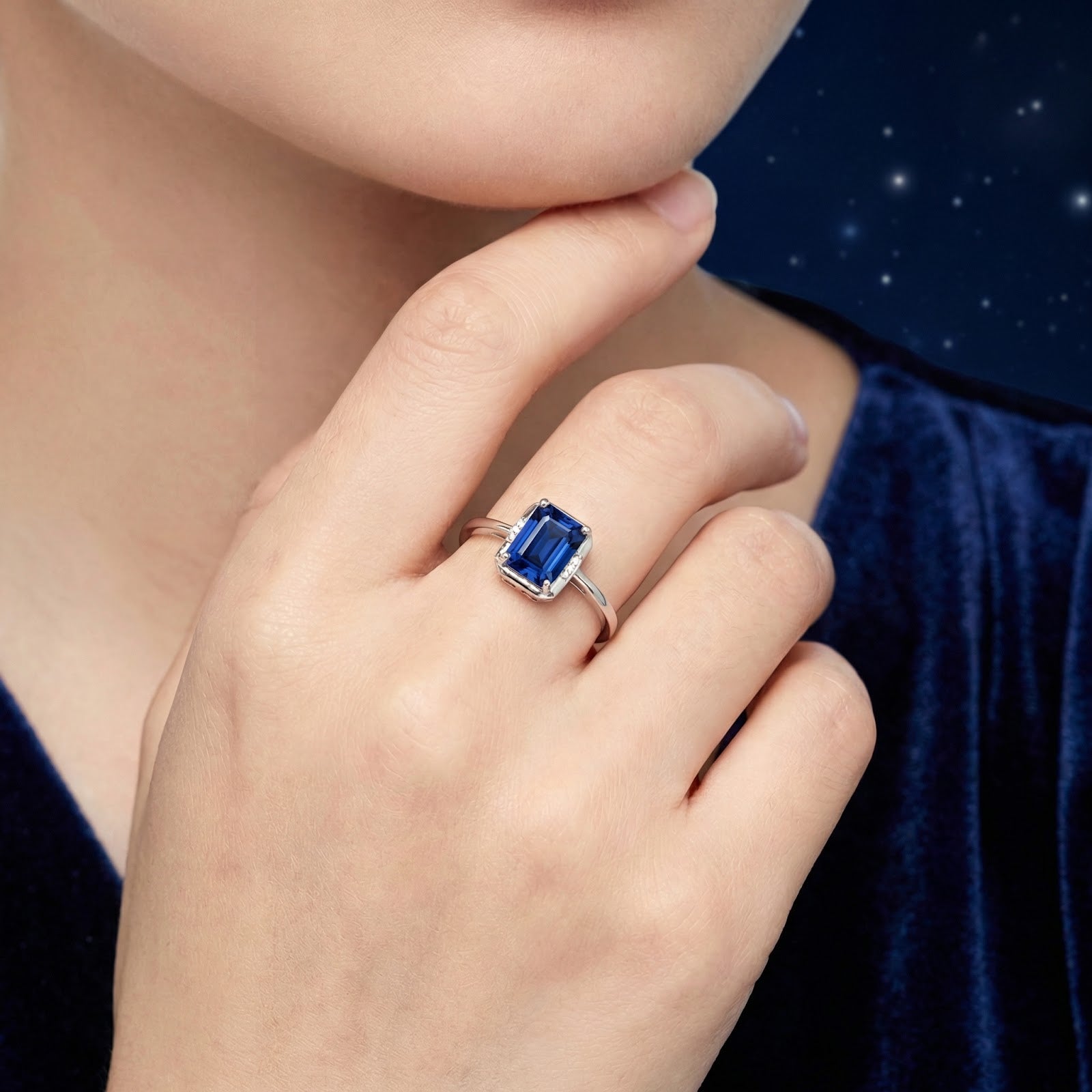 Model wearing the Mirelise emerald cut blue sapphire ring in sterling silver on her finger.