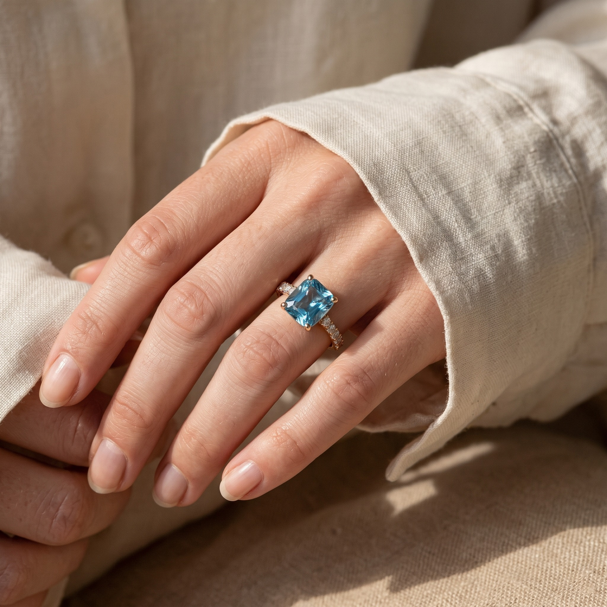 The Juliana Hope gold blue cushion ring worn by a model, cuff detail