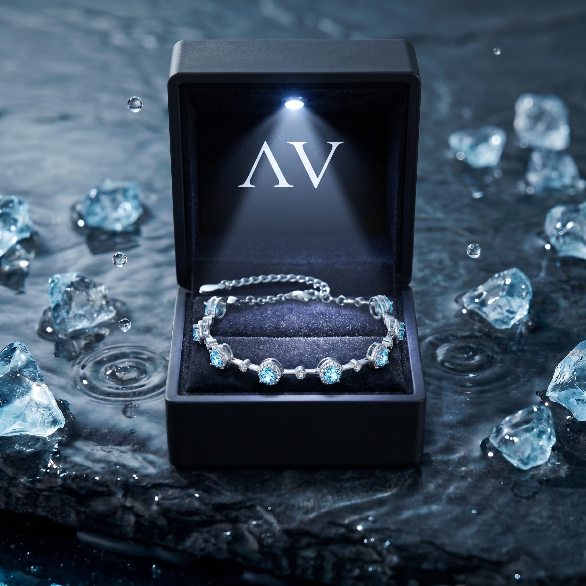 Round aquamarine sterling silver bracelet in a lighted black gift box on a wet stone background.
