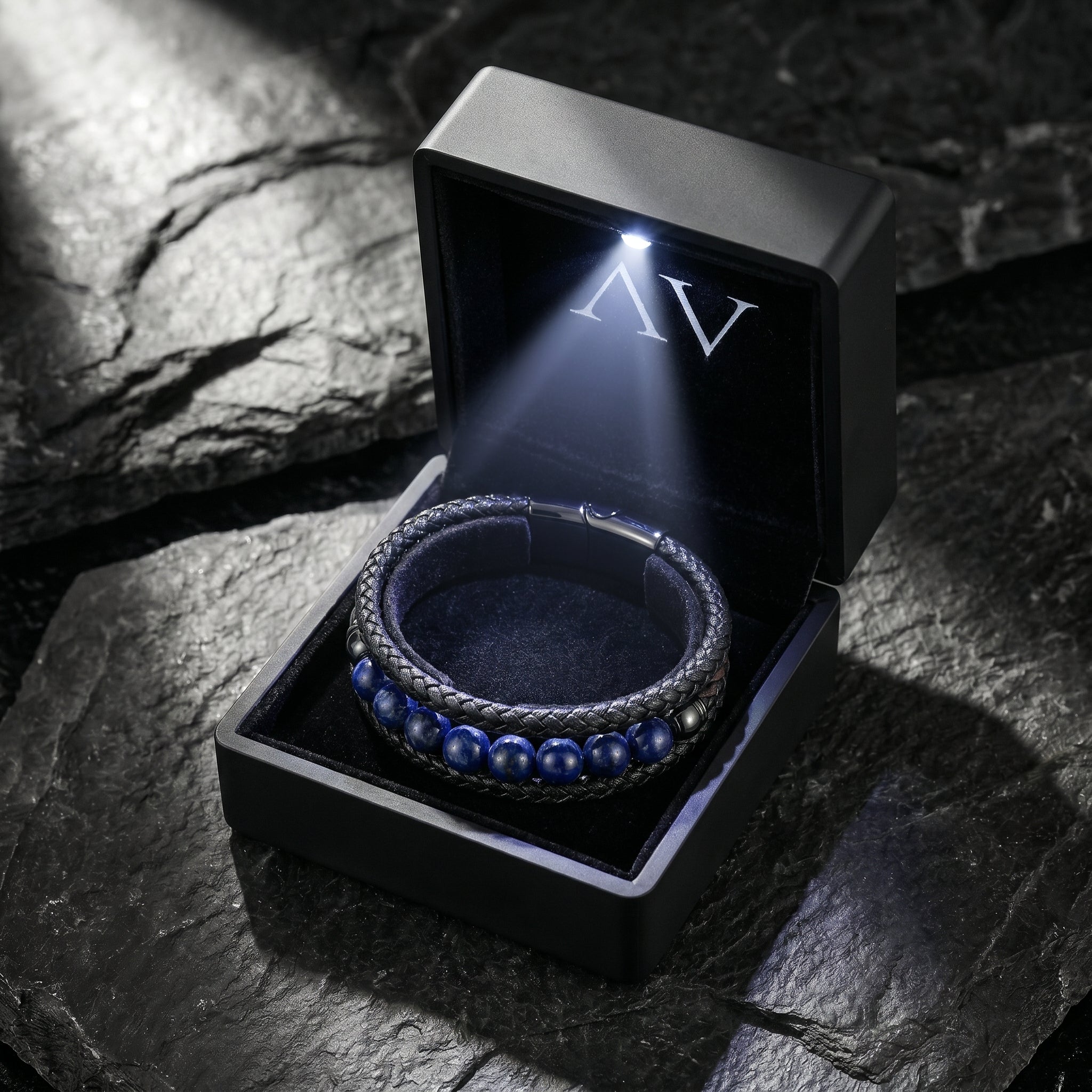 Men's black leather and blue lapis bead bracelet presented in a premium black illuminated gift box.
