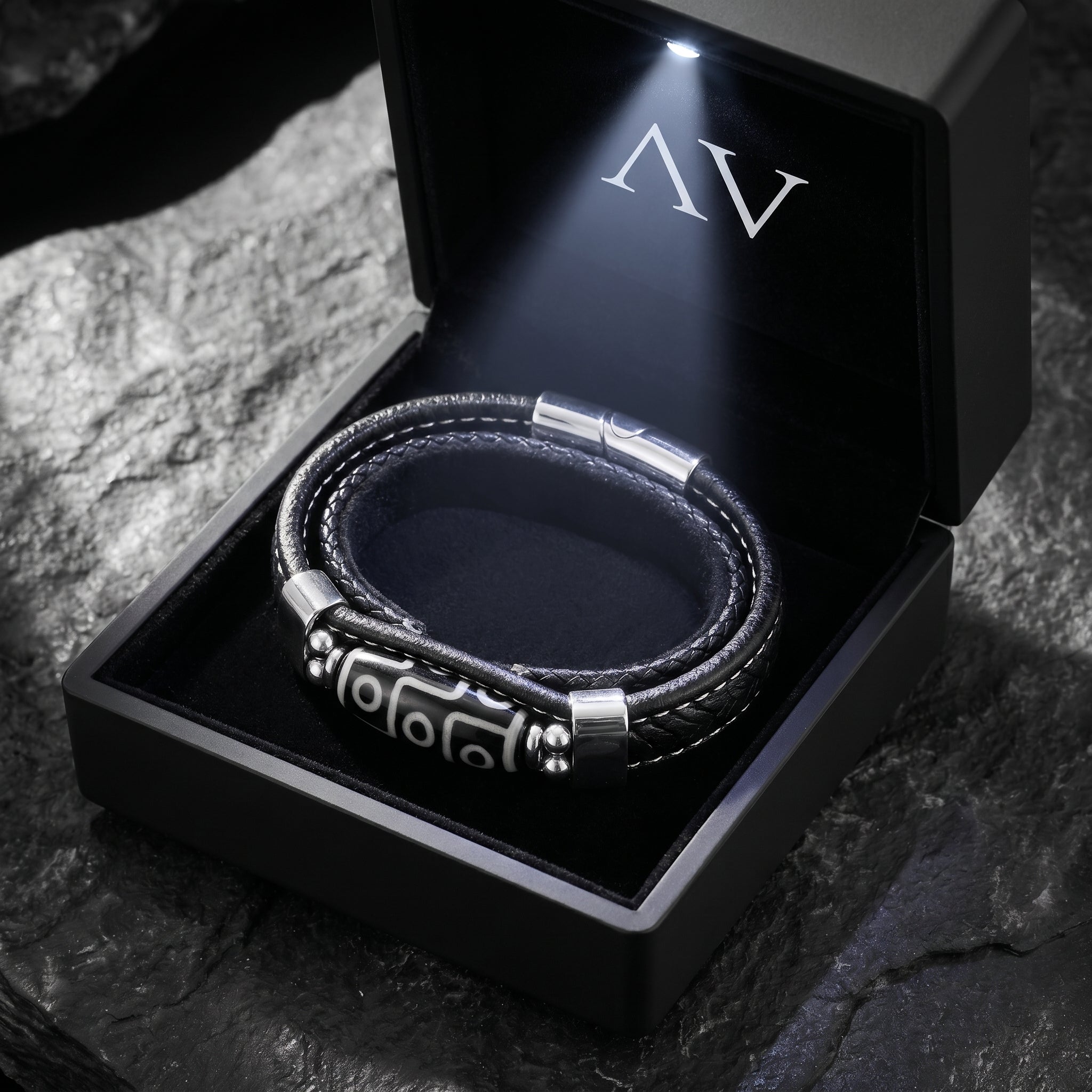 The Echelon black leather bracelet with silver steel centerpiece in a premium lighted black jewelry gift box.