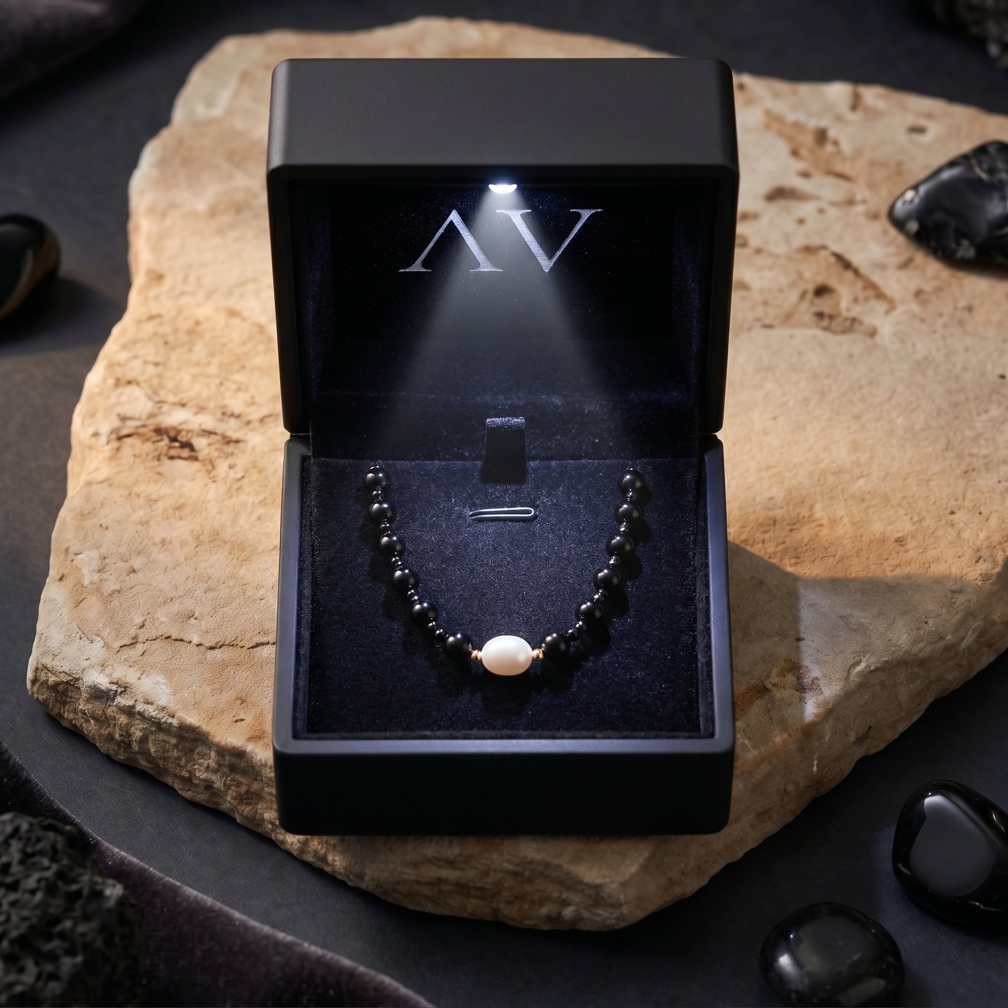 Black onyx and pearl necklace presented in a luxury black gift box with an integrated LED light.