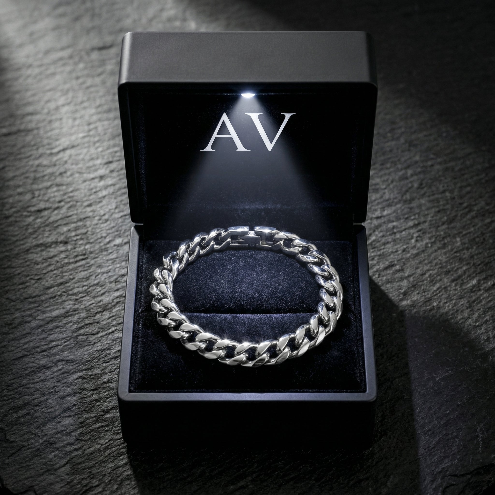 Silver stainless steel Cuban link bracelet presented in a premium black LED-lit jewelry gift box.