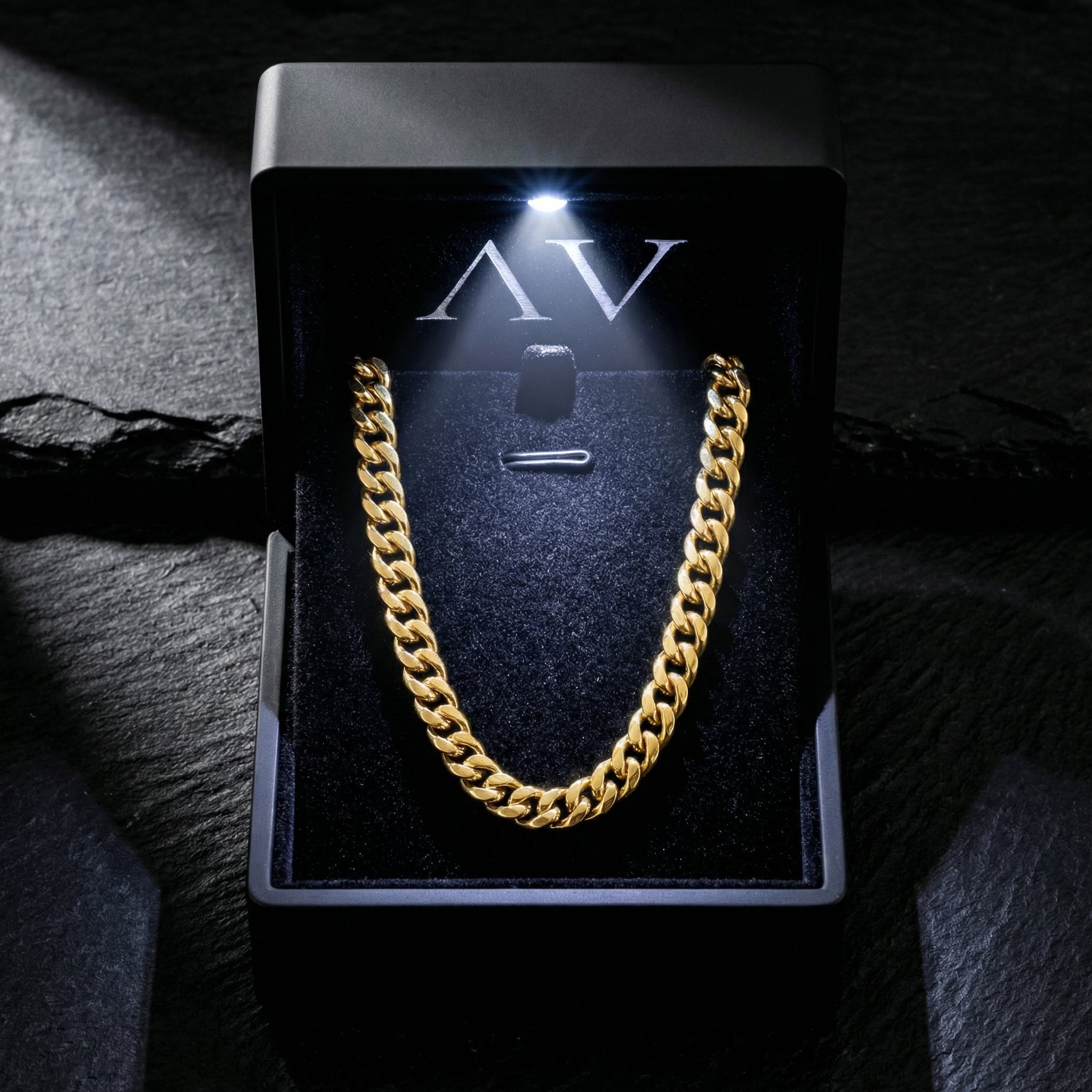 8mm gold Cuban chain in stainless steel presented in a premium black LED-lighted jewelry box.