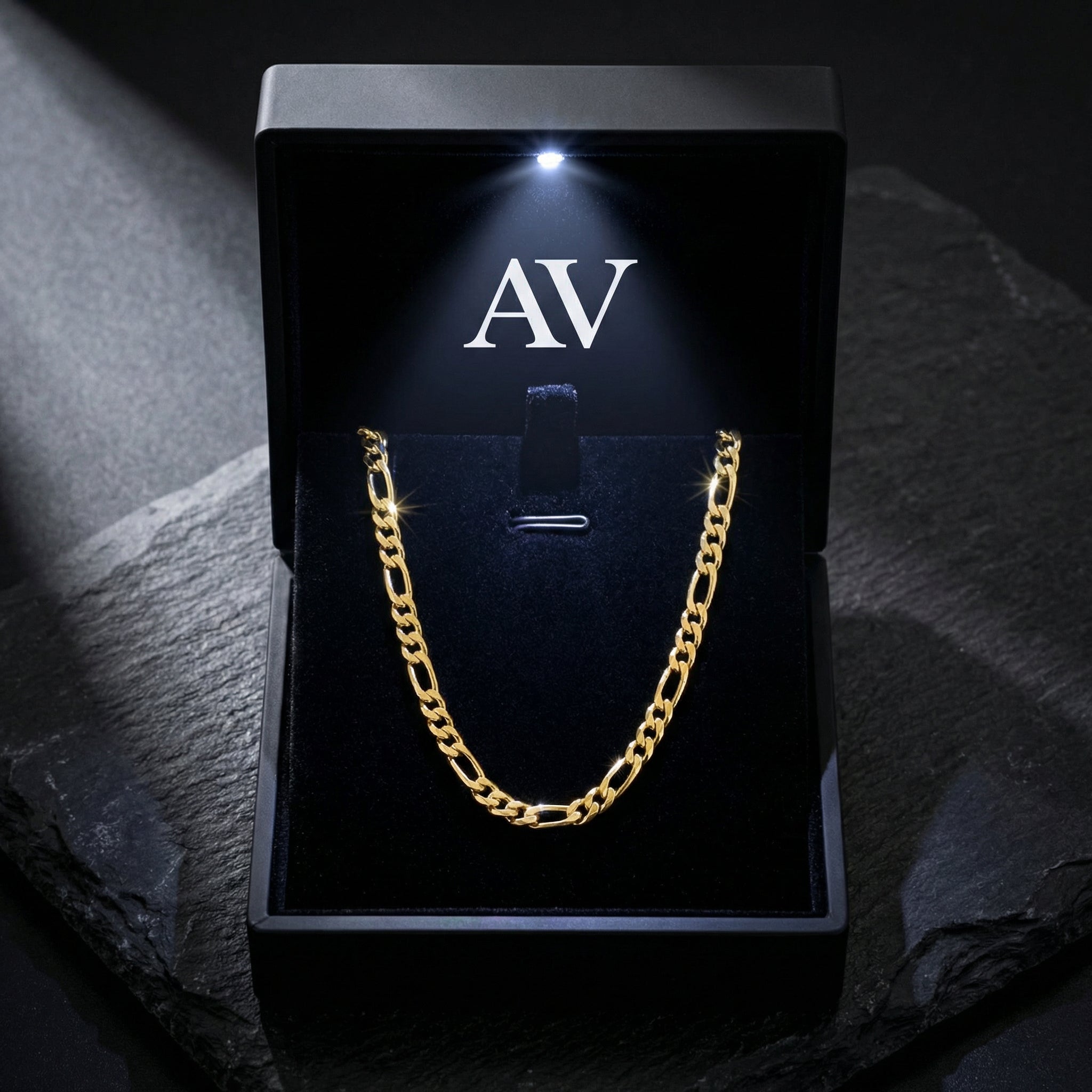 Gold Figaro chain presented in a premium black LED-lit gift box with the Awareness Avenue logo.