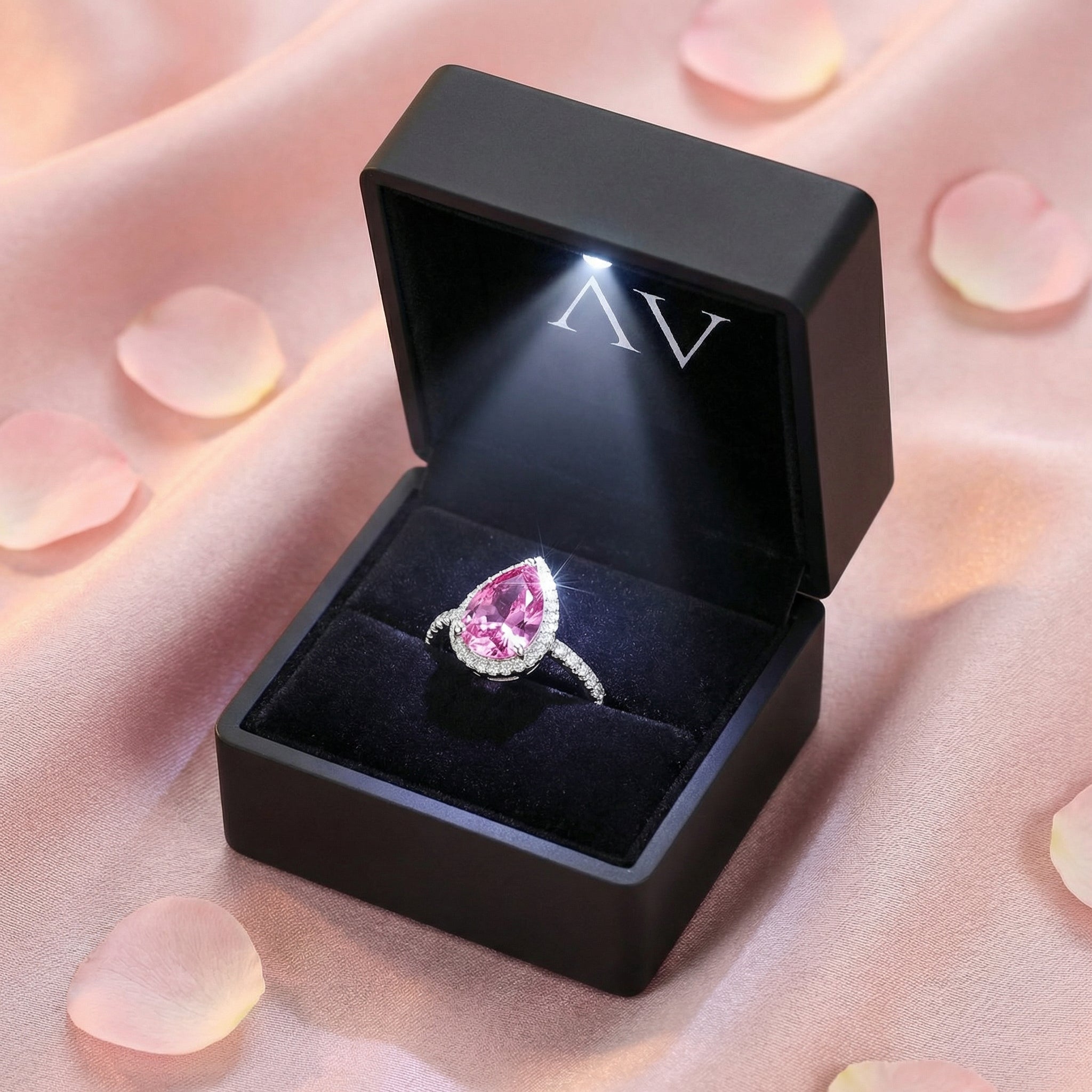 Pear-cut pink tourmaline sterling silver ring inside a black lighted jewelry presentation box.