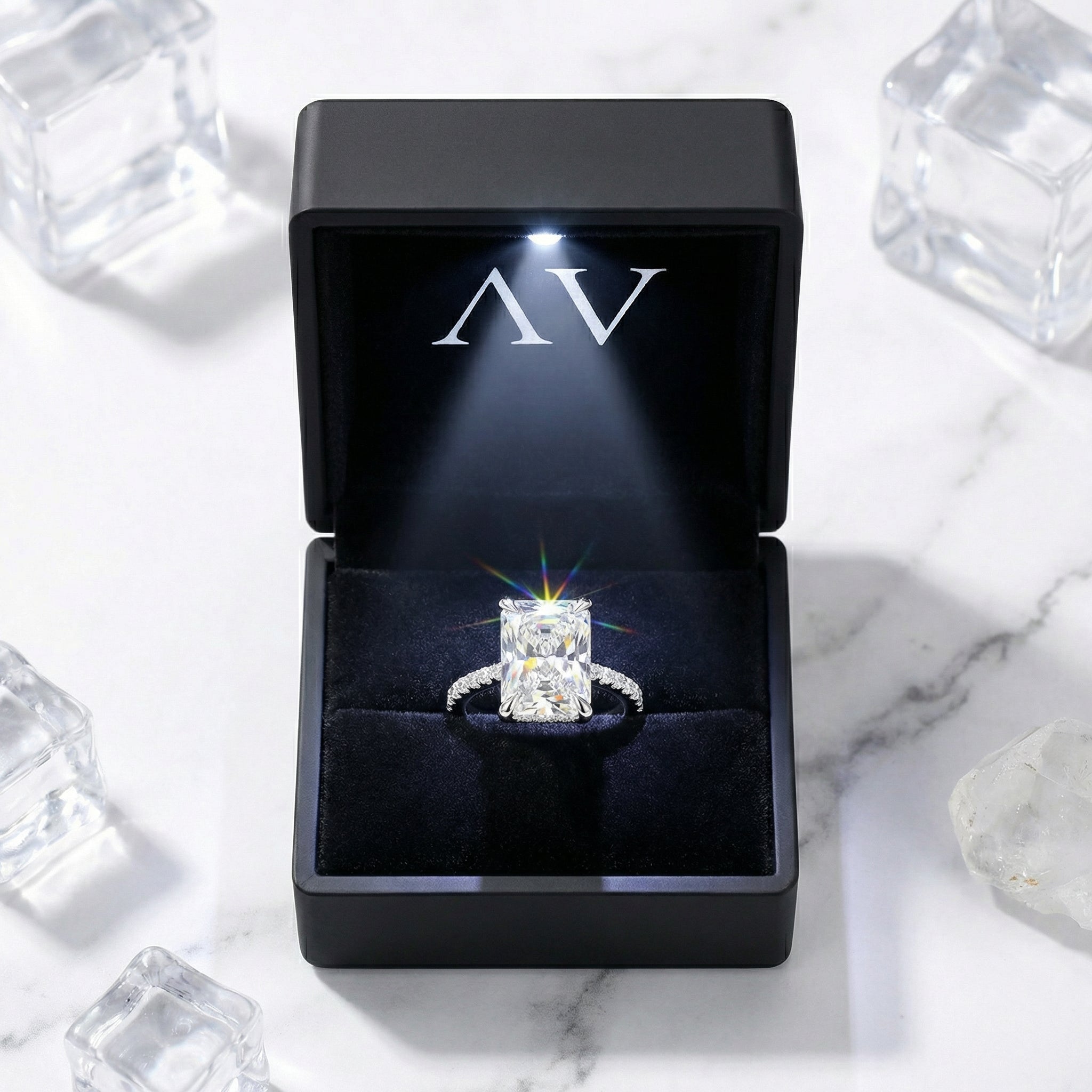 Radiant cut simulated diamond ring in S925 sterling silver presented in a black LED-lit jewelry box.