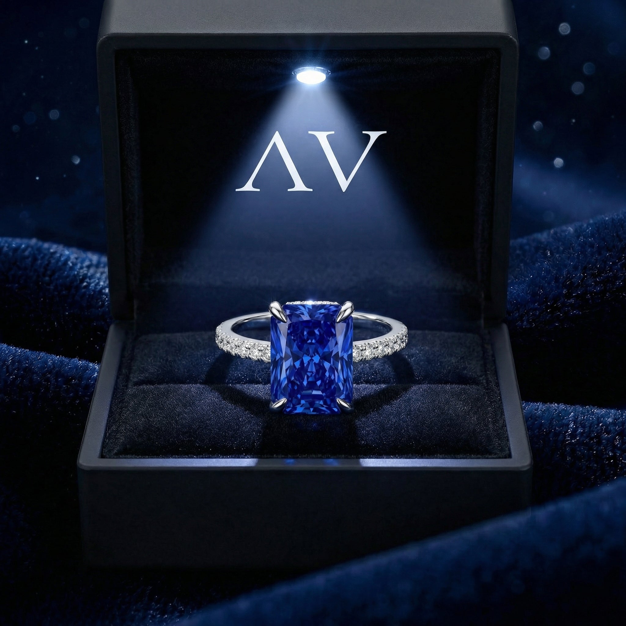 The Astris radiant cut blue sapphire ring in S925 sterling silver inside a premium lighted black jewelry box.