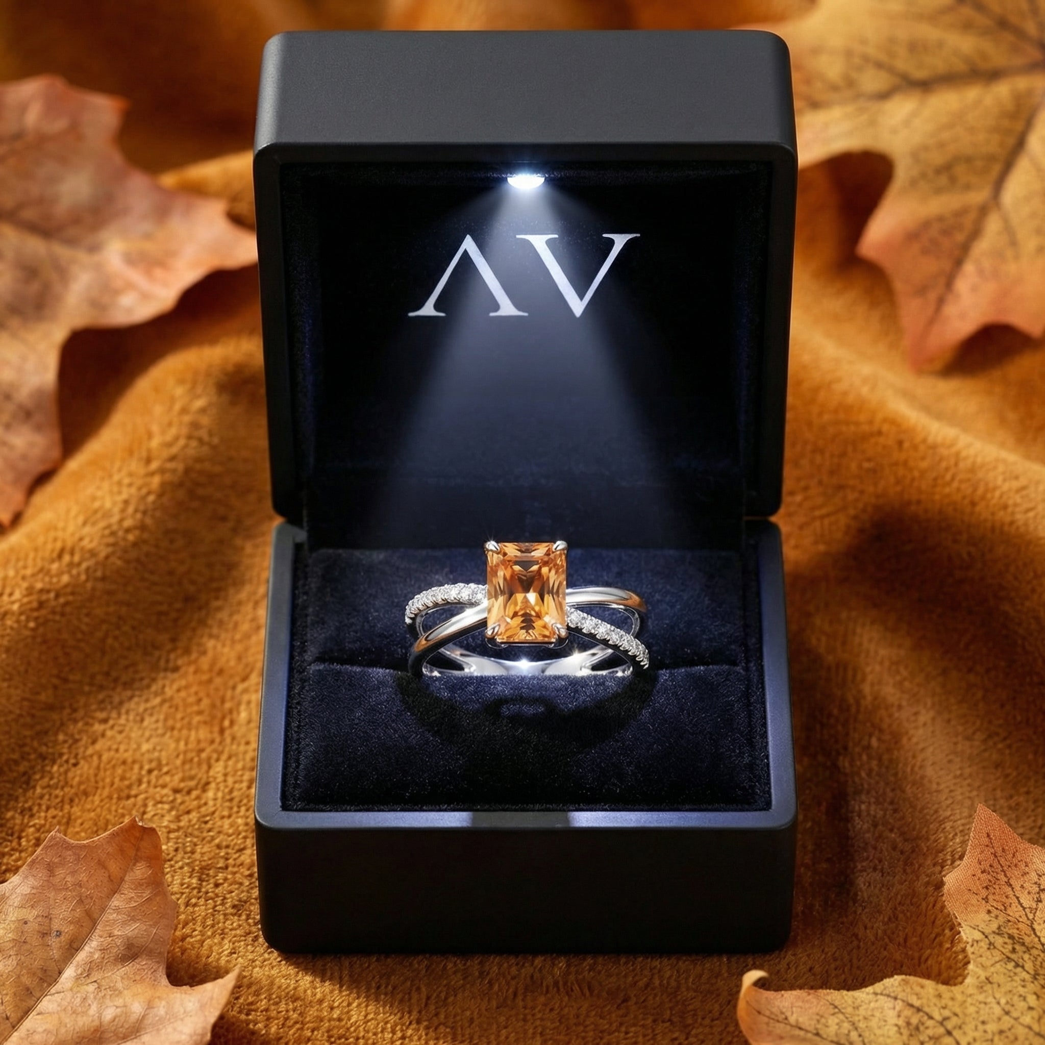 S925 sterling silver simulated topaz twist ring inside a black lighted jewelry box with AV logo.