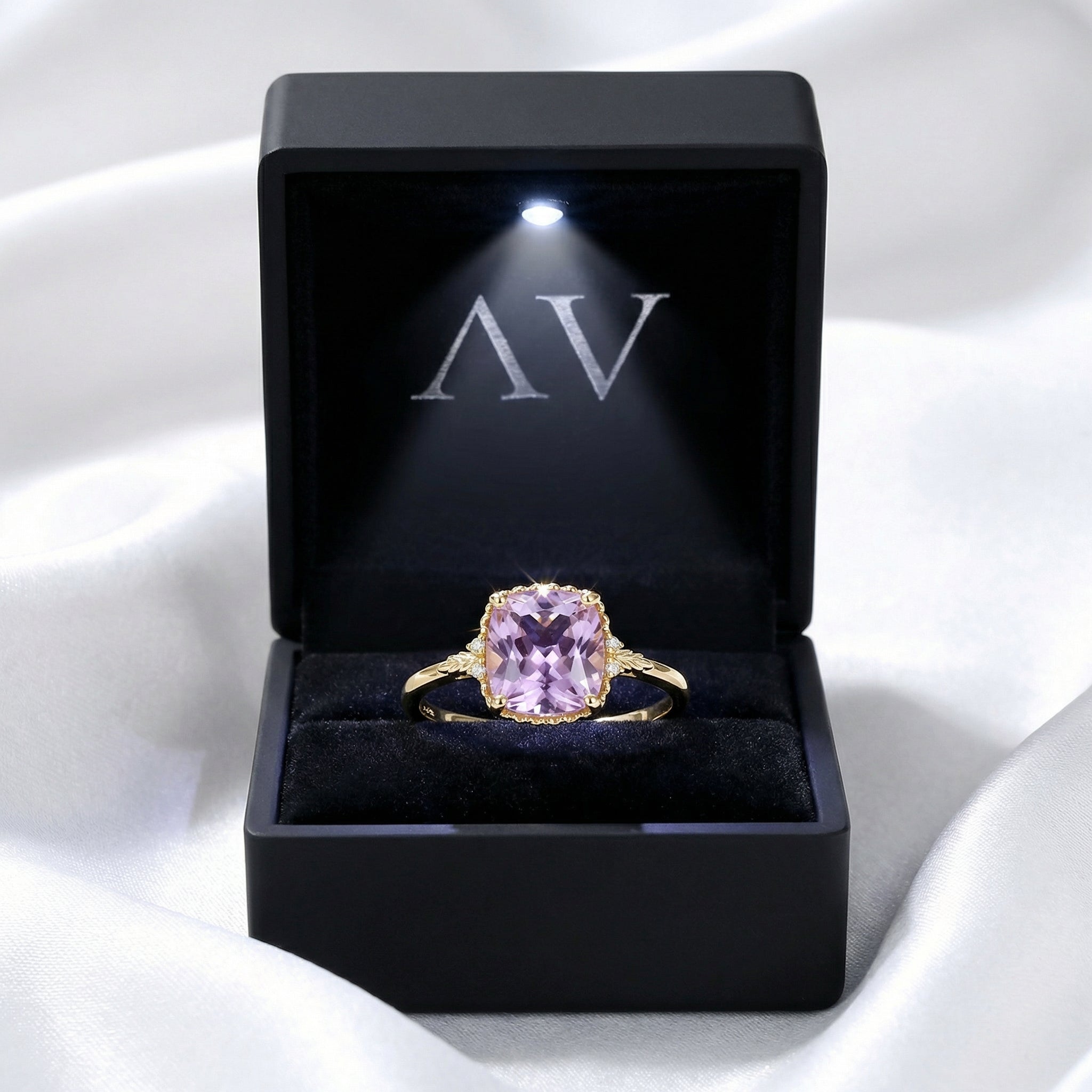 Cushion cut simulated amethyst solitaire ring in 18K gold vermeil presented in a lighted black jewelry box.