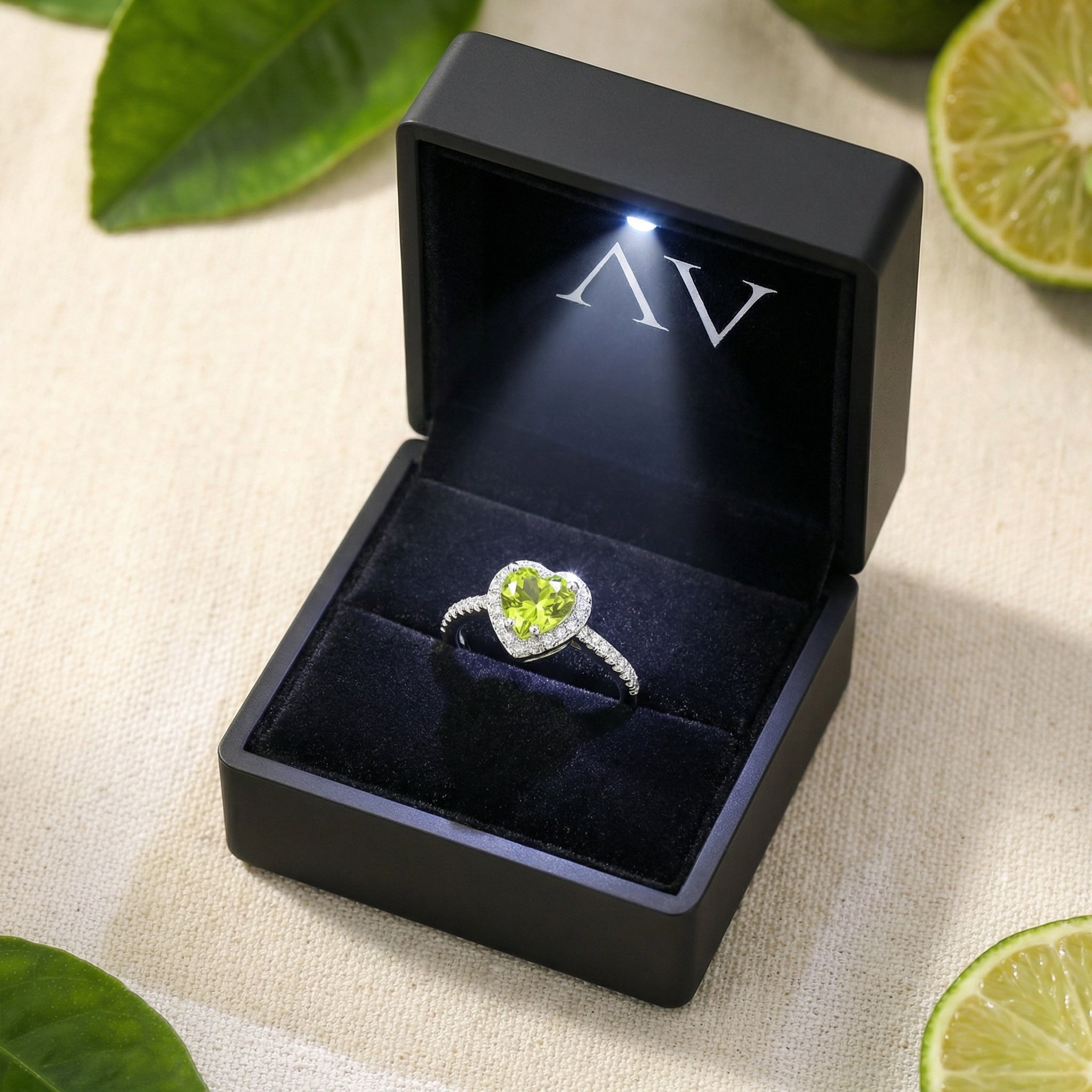 Heart-cut simulated peridot sterling silver ring presented in a black LED-lit luxury jewelry gift box.