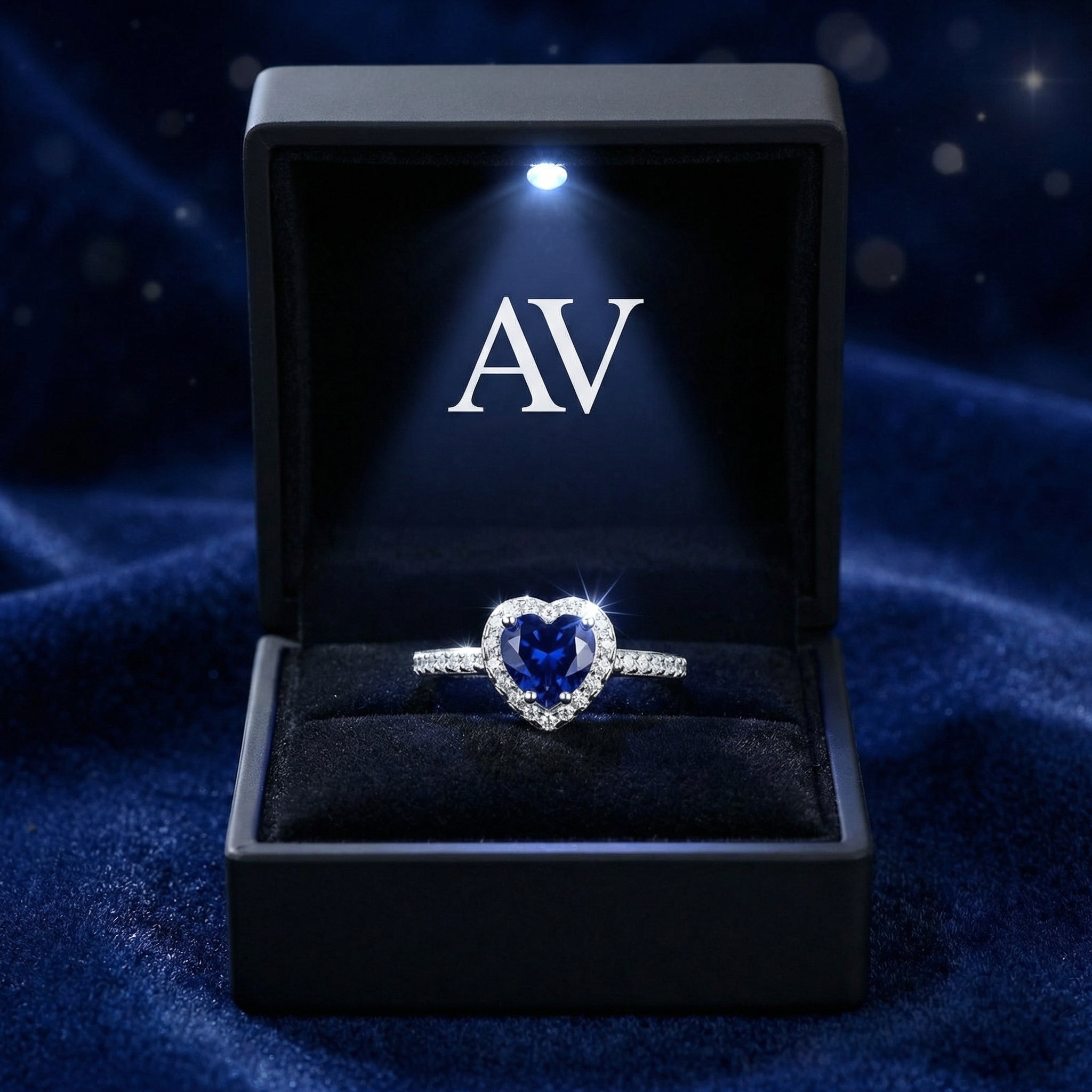 Heart-cut simulated sapphire sterling silver ring presented in a black LED-lit jewelry gift box.