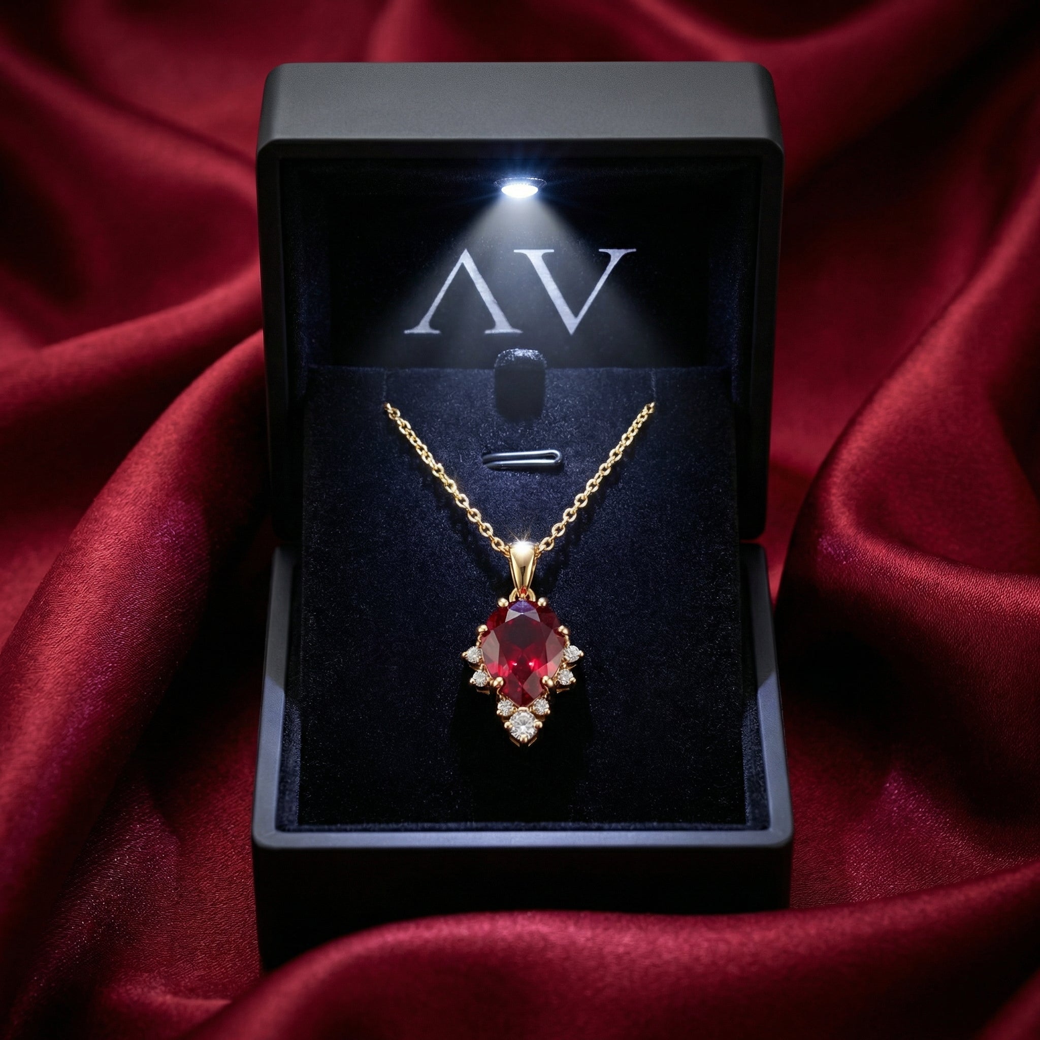 Pear cut simulated ruby necklace in 18K gold vermeil inside a premium lighted black jewelry gift box.