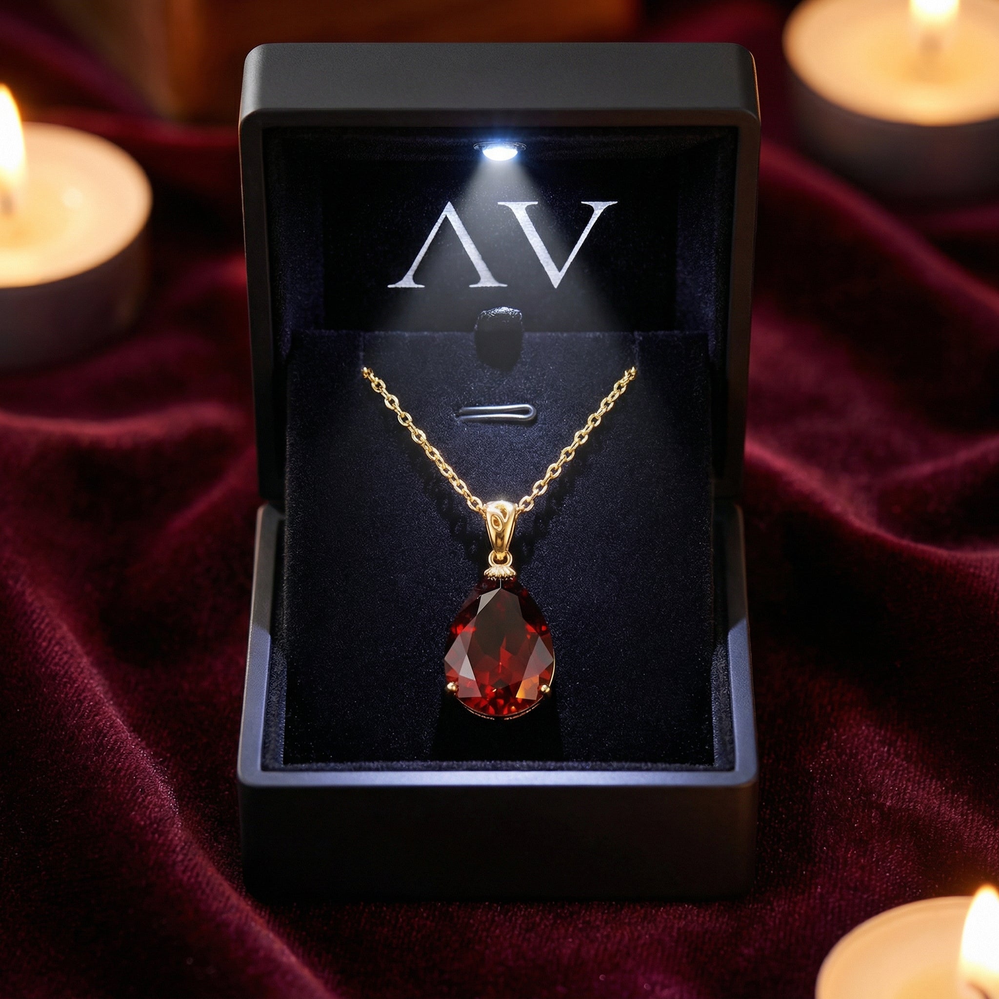 Pear cut simulated garnet necklace in 18K gold vermeil inside a premium lighted black jewelry box.