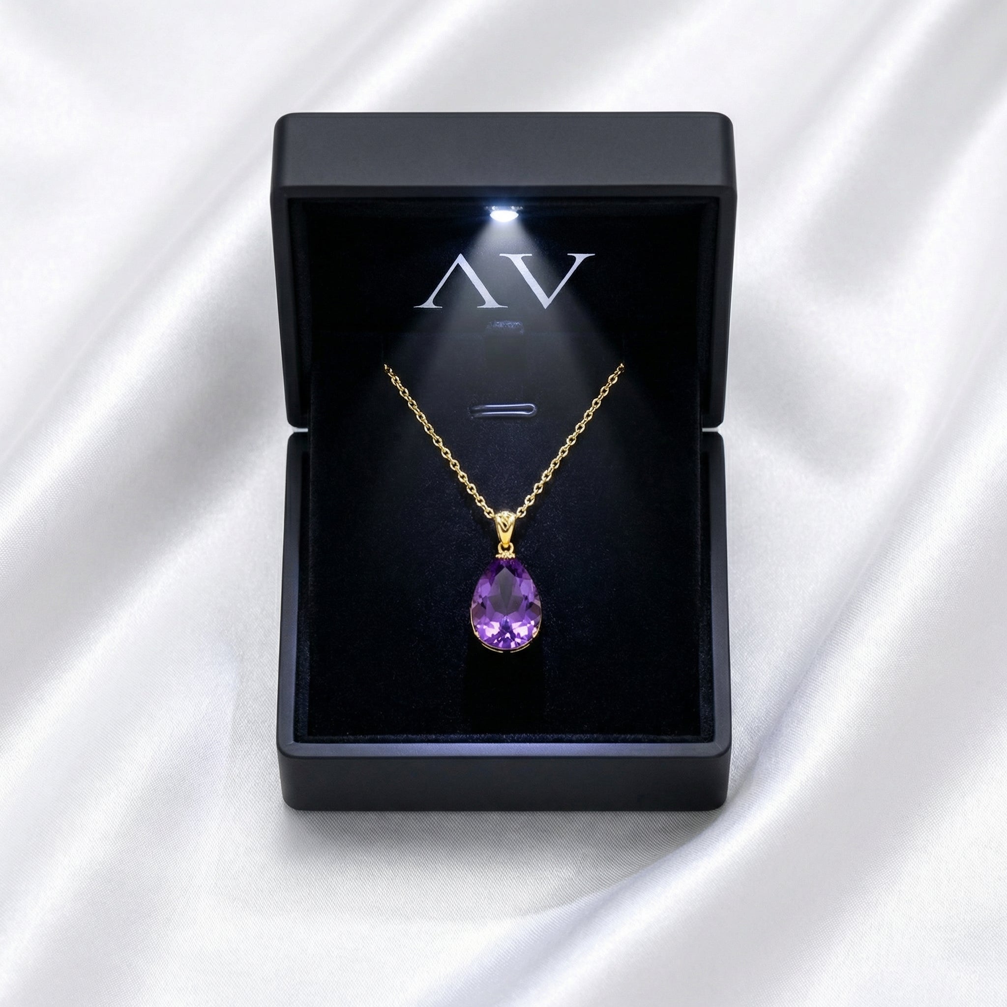 Teardrop cut simulated amethyst necklace in 18K gold vermeil inside a lighted black gift box.