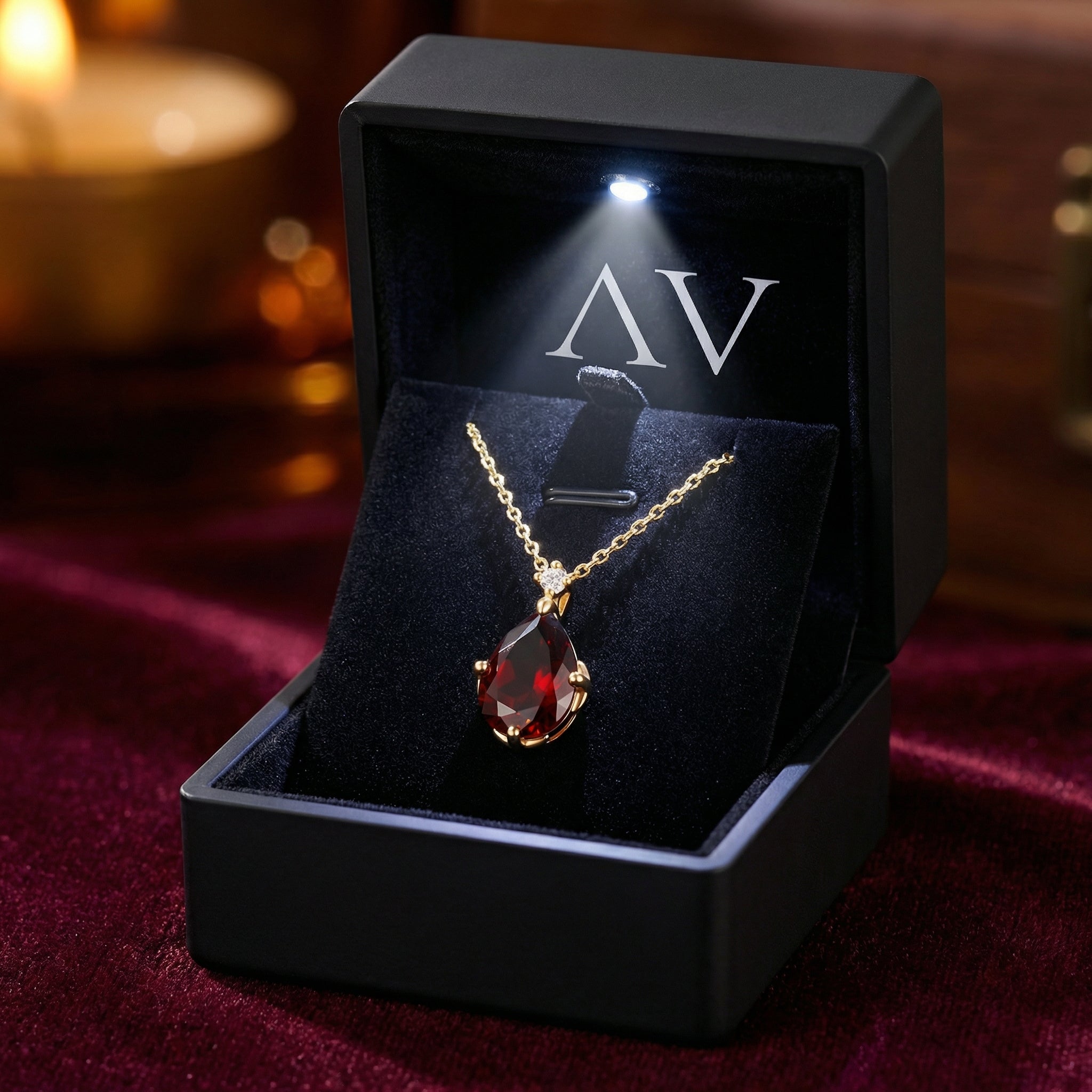 18K gold vermeil pear cut simulated garnet necklace presented in a black LED-lit jewelry gift box.