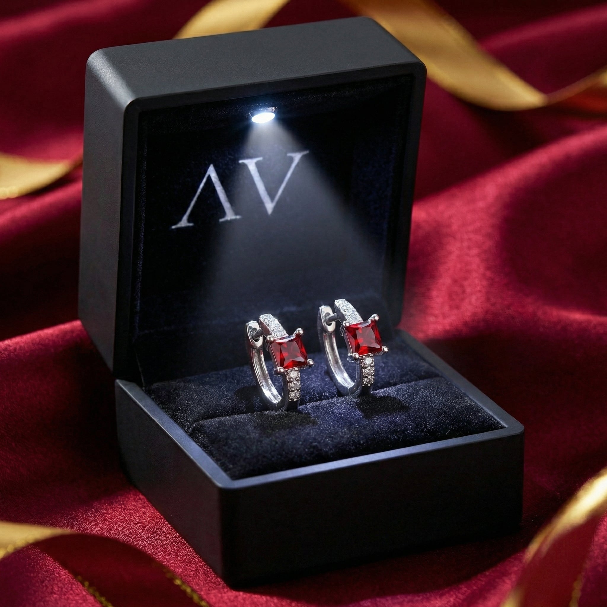 Sterling silver square huggie earrings with red rubies in a premium lighted gift box.