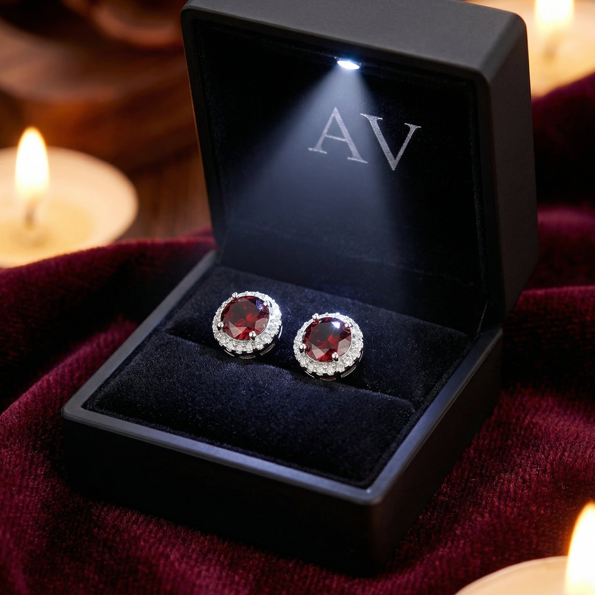 Round simulated garnet halo stud earrings in S925 sterling silver inside a black LED-lit jewelry gift box.