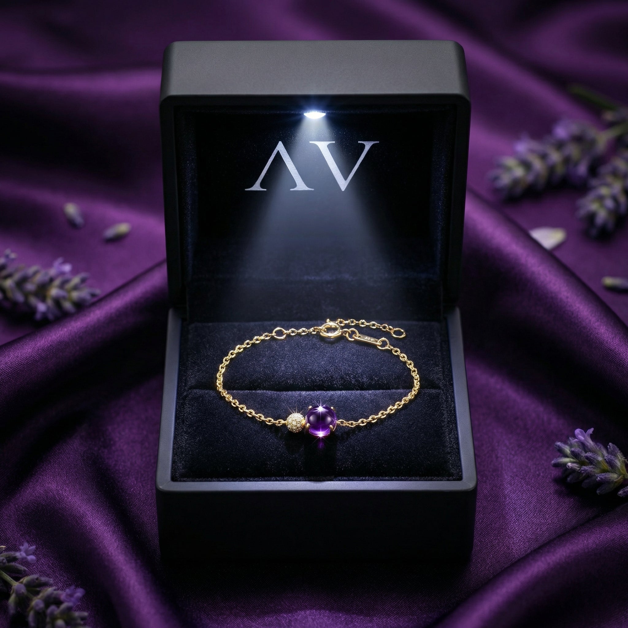 18K yellow gold Veraline round cut amethyst bracelet inside a lighted black AV branded jewelry box.