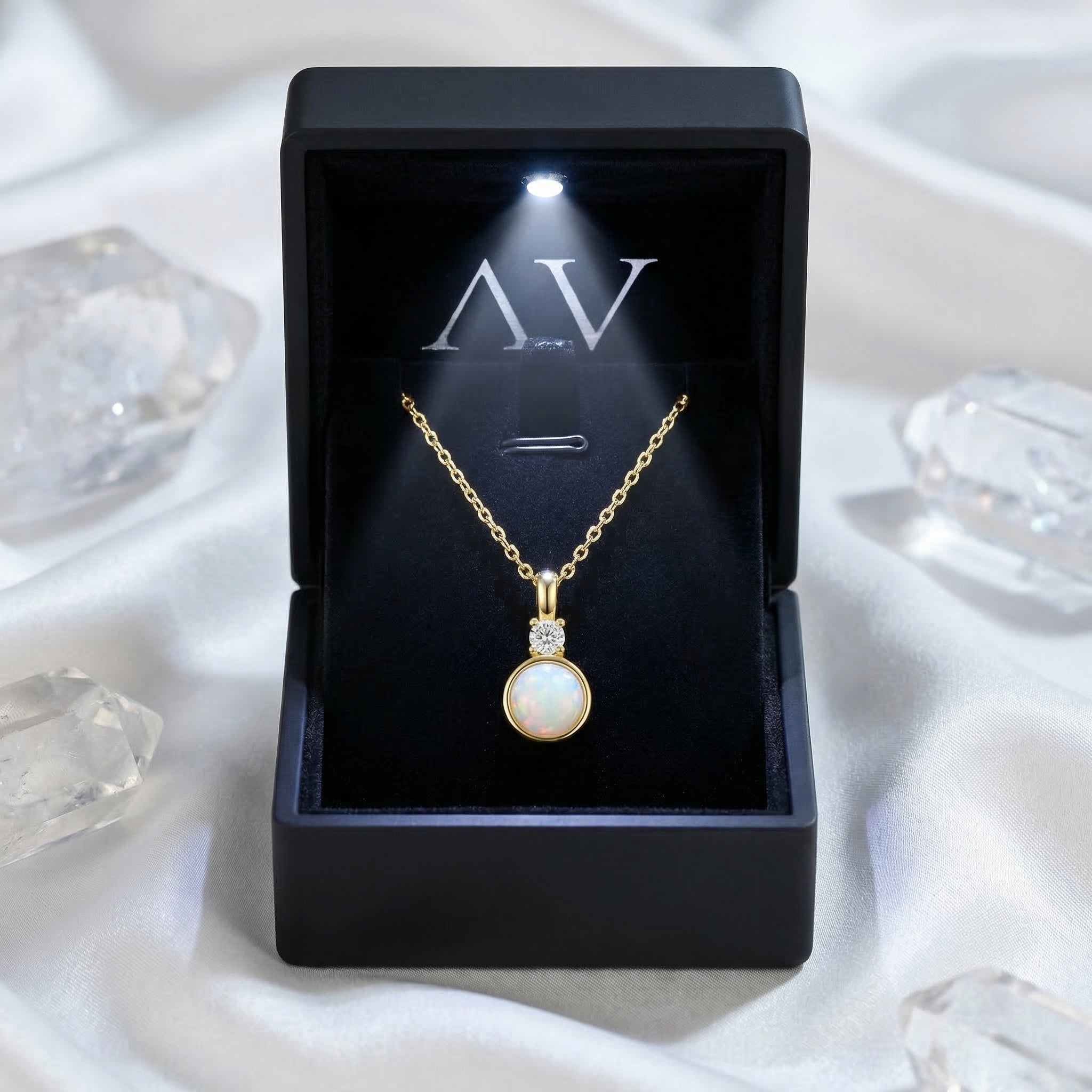 Yellow gold round white opal pendant necklace inside a black lighted jewelry gift box with AV logo.