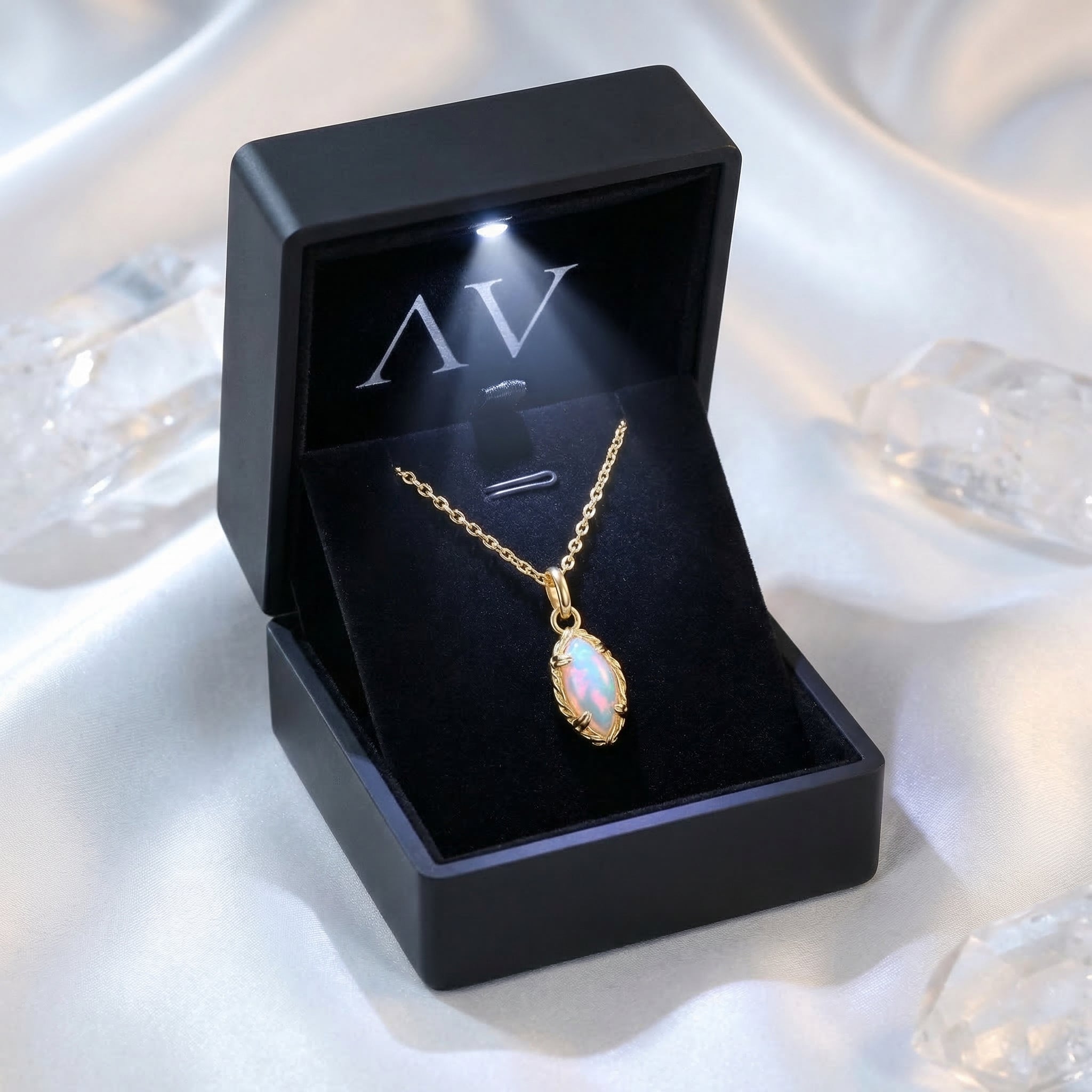 Gold marquise-cut white opal necklace presented in a premium black LED-lit jewelry gift box.