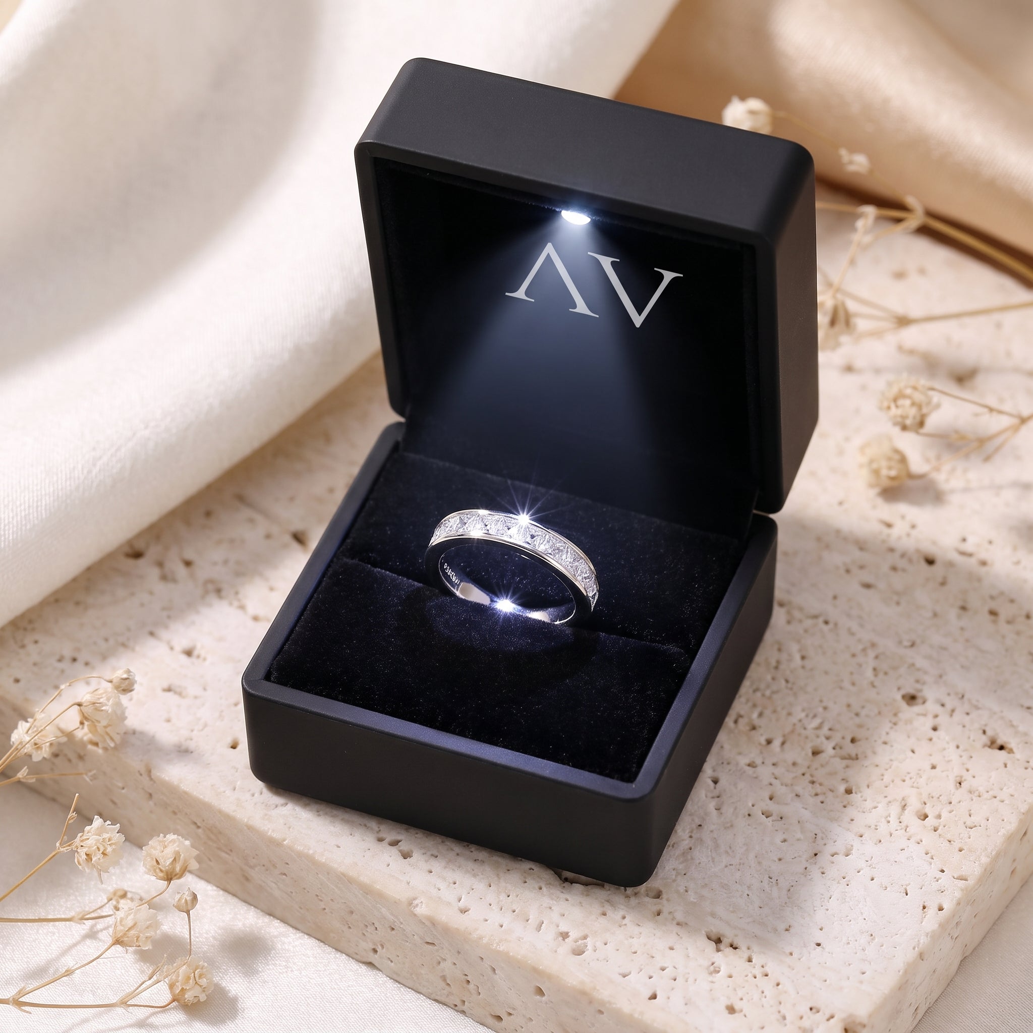 Sterling silver princess cut eternity ring inside a black LED-lit jewelry gift box.