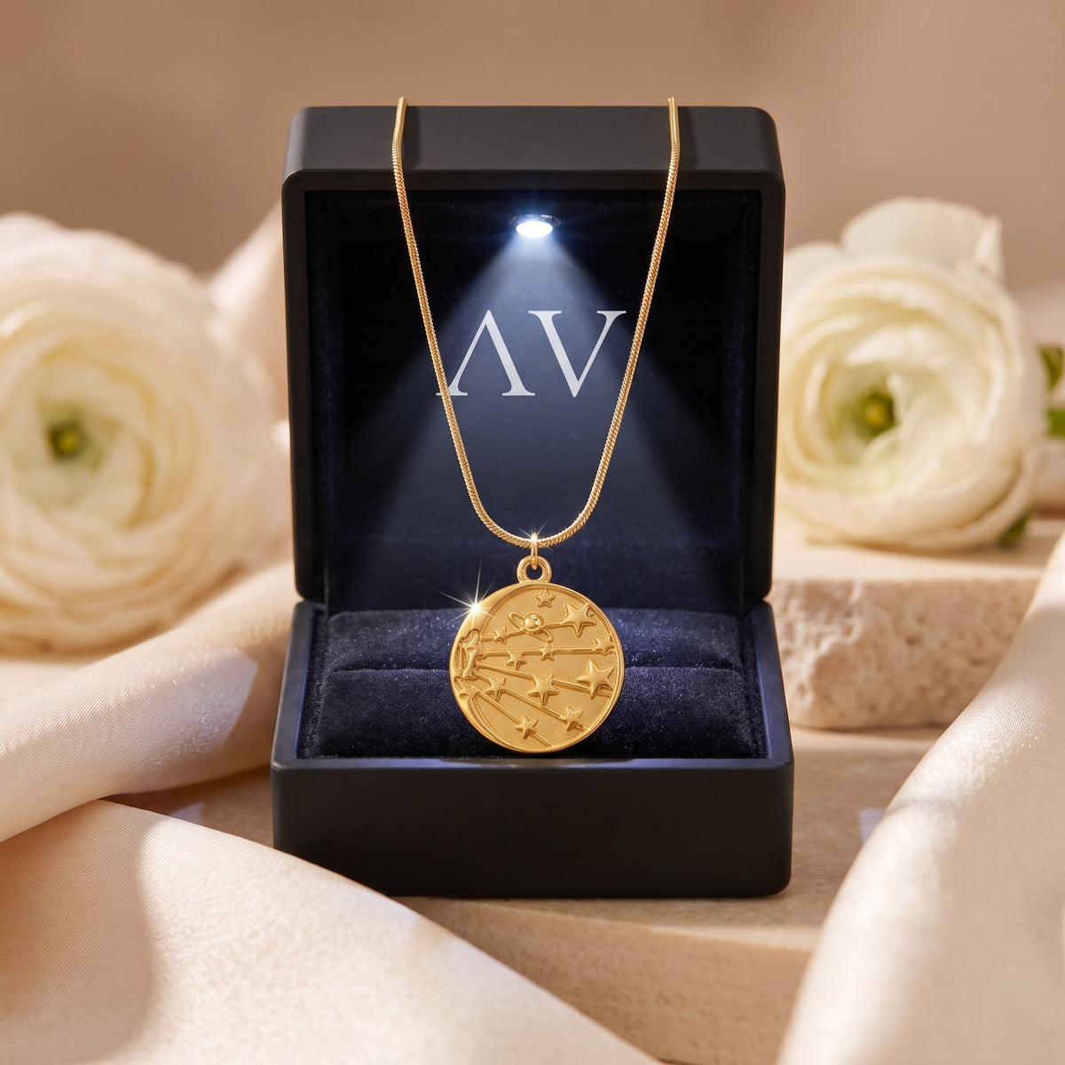 18K gold celestial medallion necklace in a black LED-lit jewelry gift box.