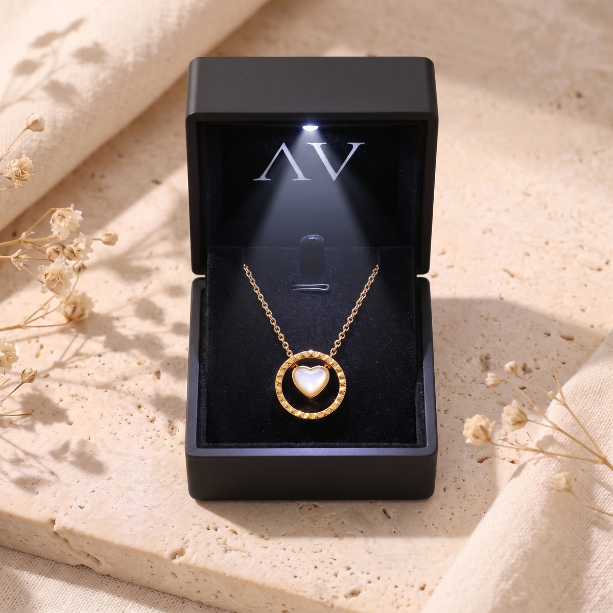 Gold Rosetta mother of pearl necklace in a black LED-lit jewelry gift box.